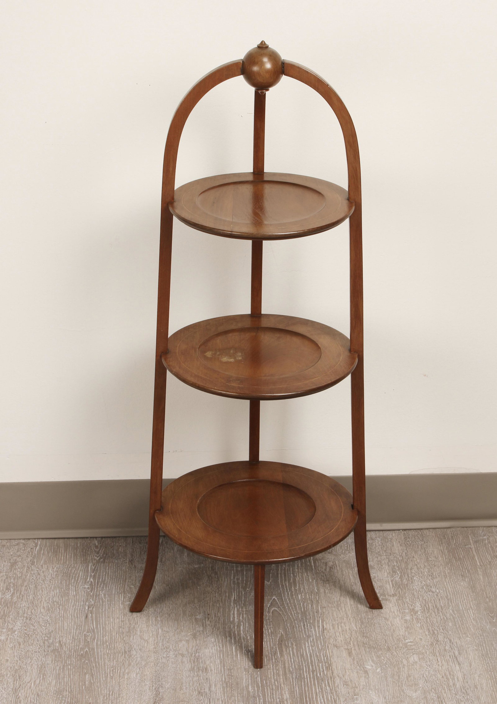 ENGLISH ROUND THREE TIER SIDE TABLE MUFFIN STAND: Three round levels in mahogany with satinwood inlay. Curved legs with inlay. Levels are indented in center. 35" x 15" $200 - $400 Please contact us for high resolution images of this