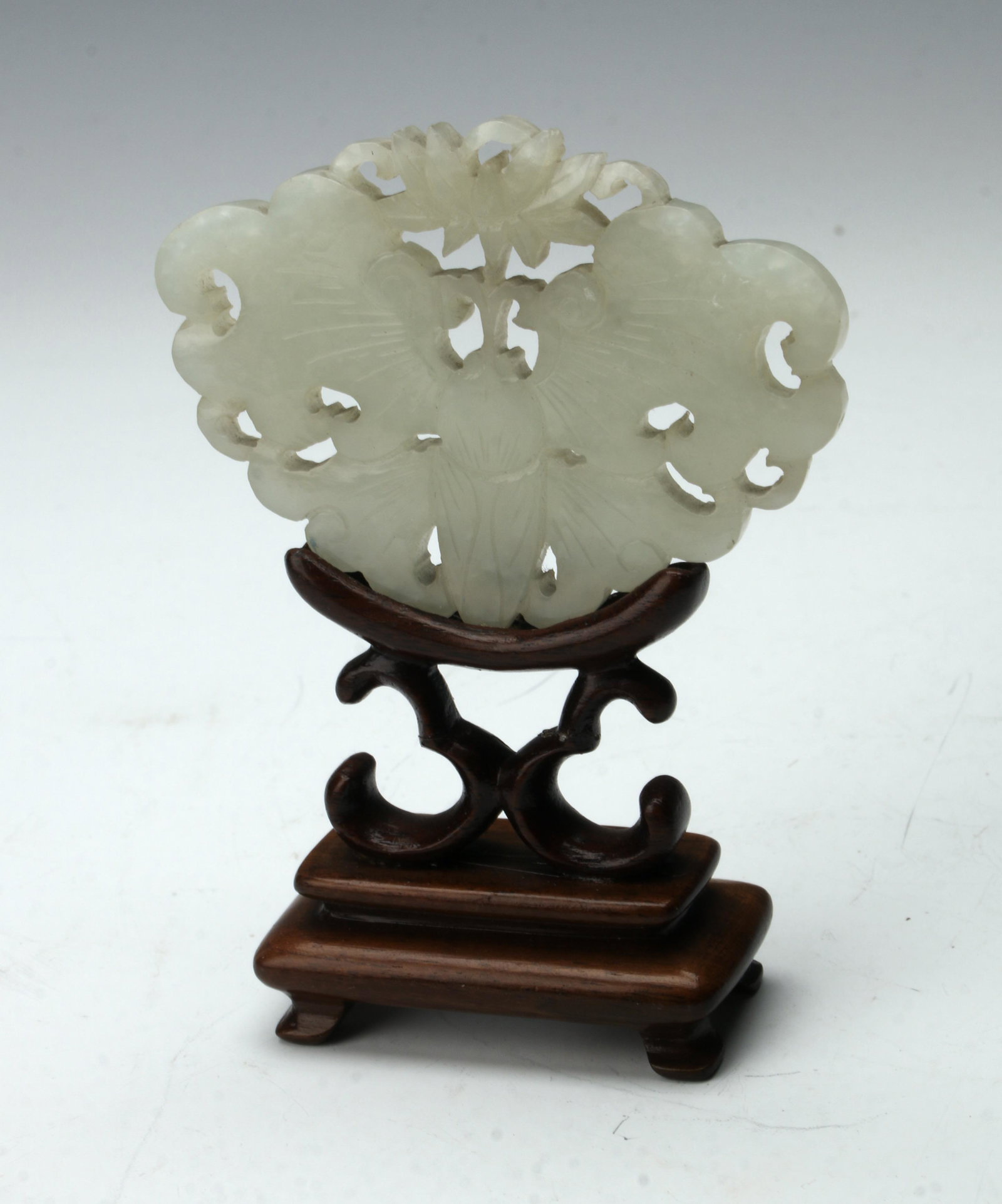 SMALL JADE MEDALLION ON STAND: Small carved butterfly with a lotus blossom above. On custom carved stand. 2" X 4" $400 - $600 Please contact us for high resolution images of this lot. Shipping: