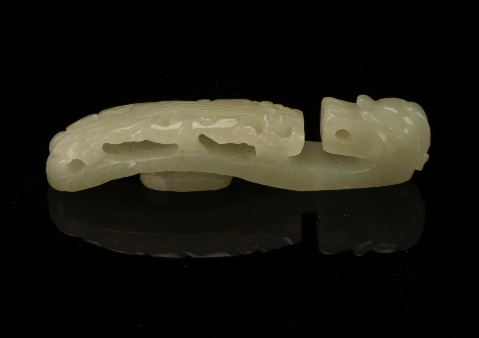 SMALL JADE DRAGON BUCKLE: In the form of a dragon with carved head and body. Smooth on the back. 2 3/4" $300 - $500 Please contact us for high resolution images of this lot. Shipping: