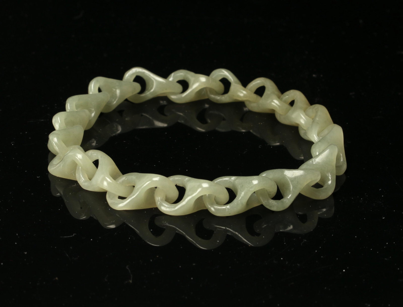 JADE CHAIN LINK BANGLE: Interlocking jade links make up this bangle. 3" $300 - $500 Please contact us for high resolution images of this lot. Shipping: We are able to pack and ship t