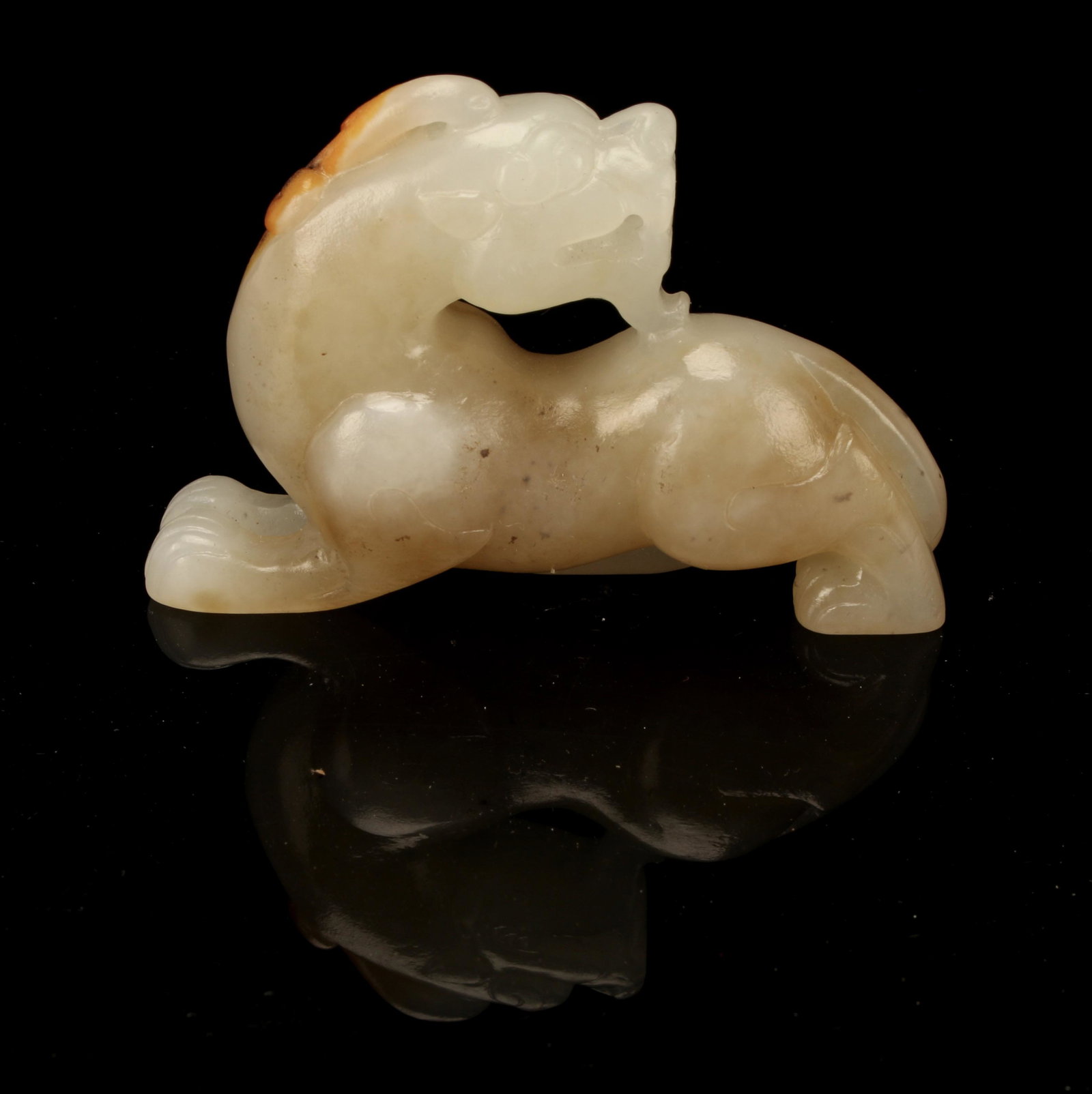 SMALL CARVED JADE BEAST: Jade beast carving with an open mouth showing teeth. 2" x 2" $200 - $400 Please contact us for high resolution images of this lot. Shipping: We are able t