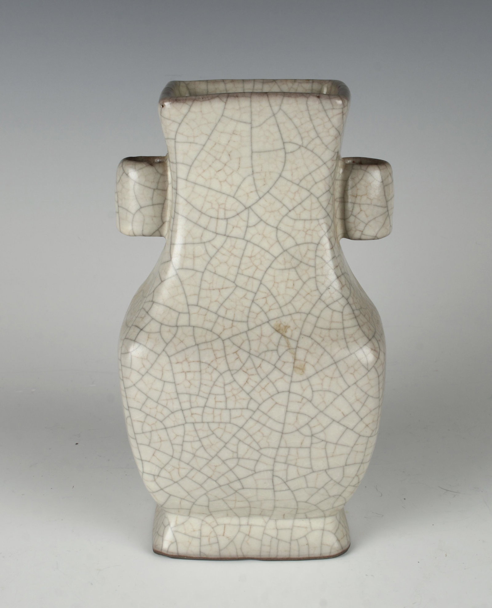 BEIGE CRACKLE VASE WITH TUBULAR HANDLES: All over craquelure on a beige vase with tubular handles. 4" X 7 1/2" $400 - $600 Please contact us for high resolution images of this lot. Shipping: We