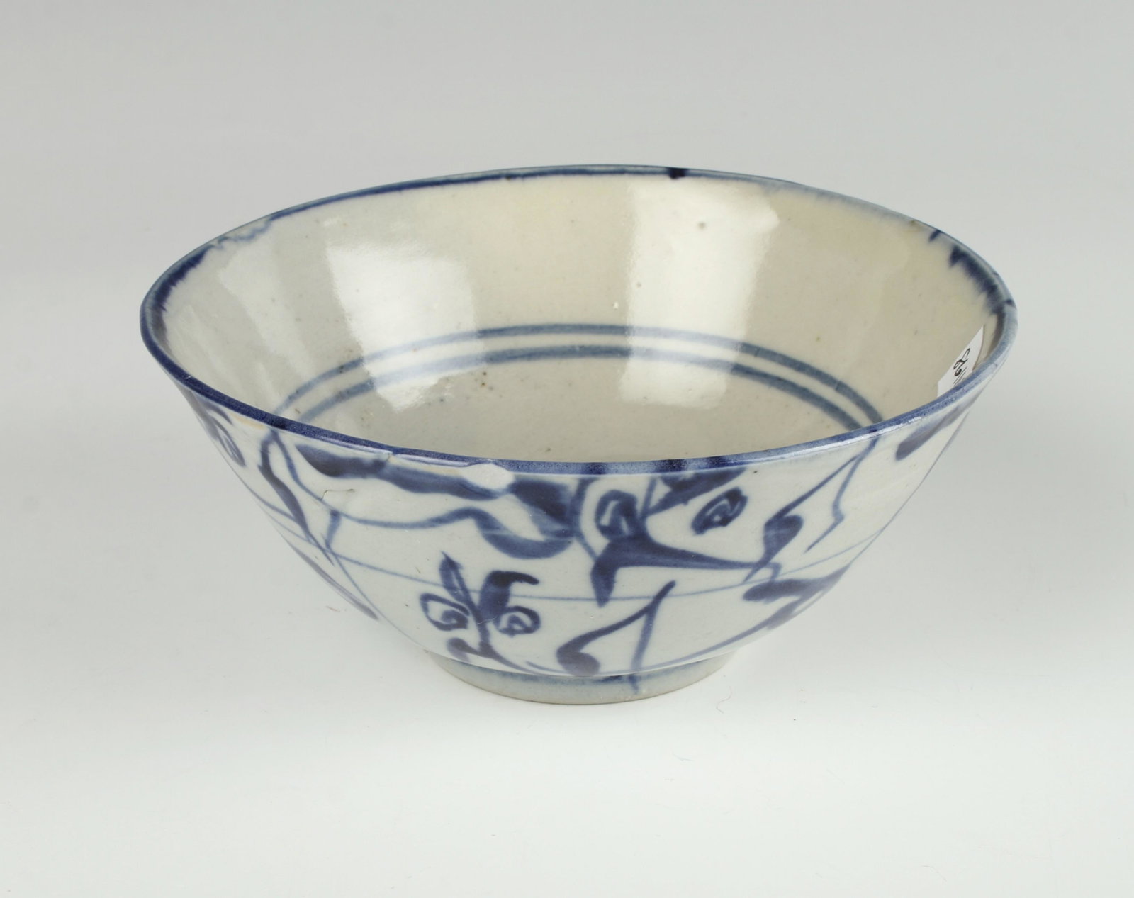 BLUE & WHITE ASIAN BOWL: Gestural painting of flowers on the outside. Two bands of blue on the outside with a central brush mark. Four character mark on bottom. 5 1/2" X 2 1/2" $40 - $80 Please contact us for
