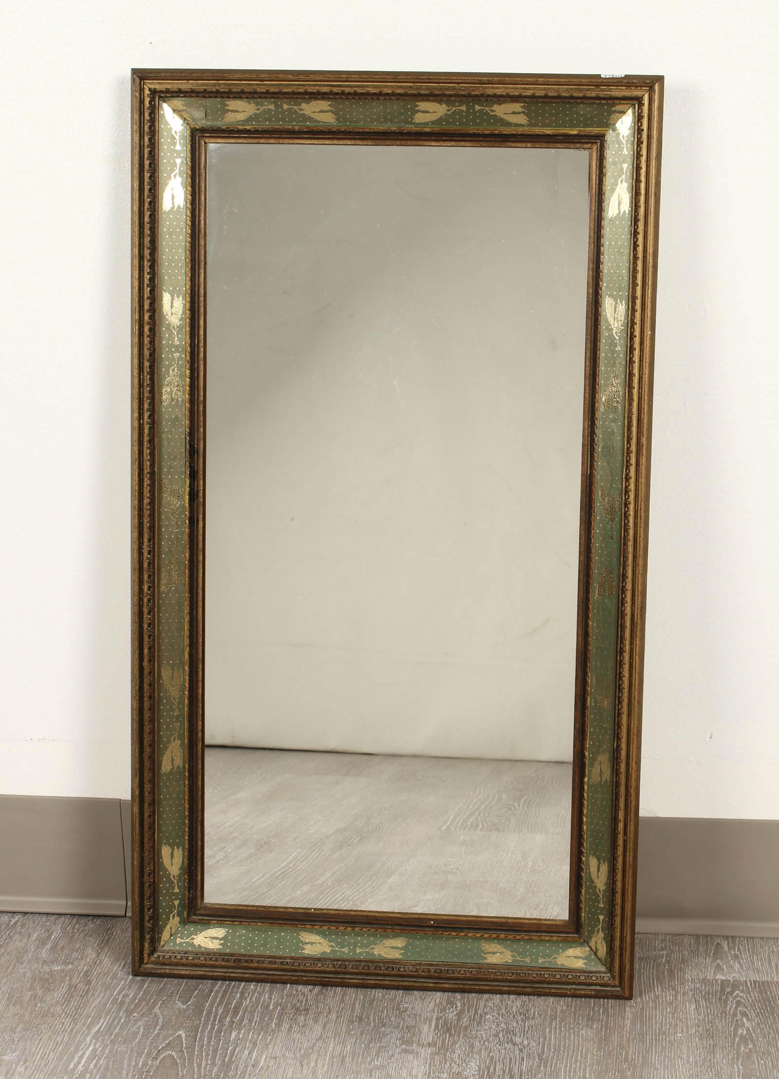 WOODEN MIRROR WITH ANGEL RIBBON TRIM: Embellished with green and gold angel ribbon trim. 15 1/2" X 27 1/2" $40 - $80 Please contact us for high resolution images of this lot. Shipping: We are