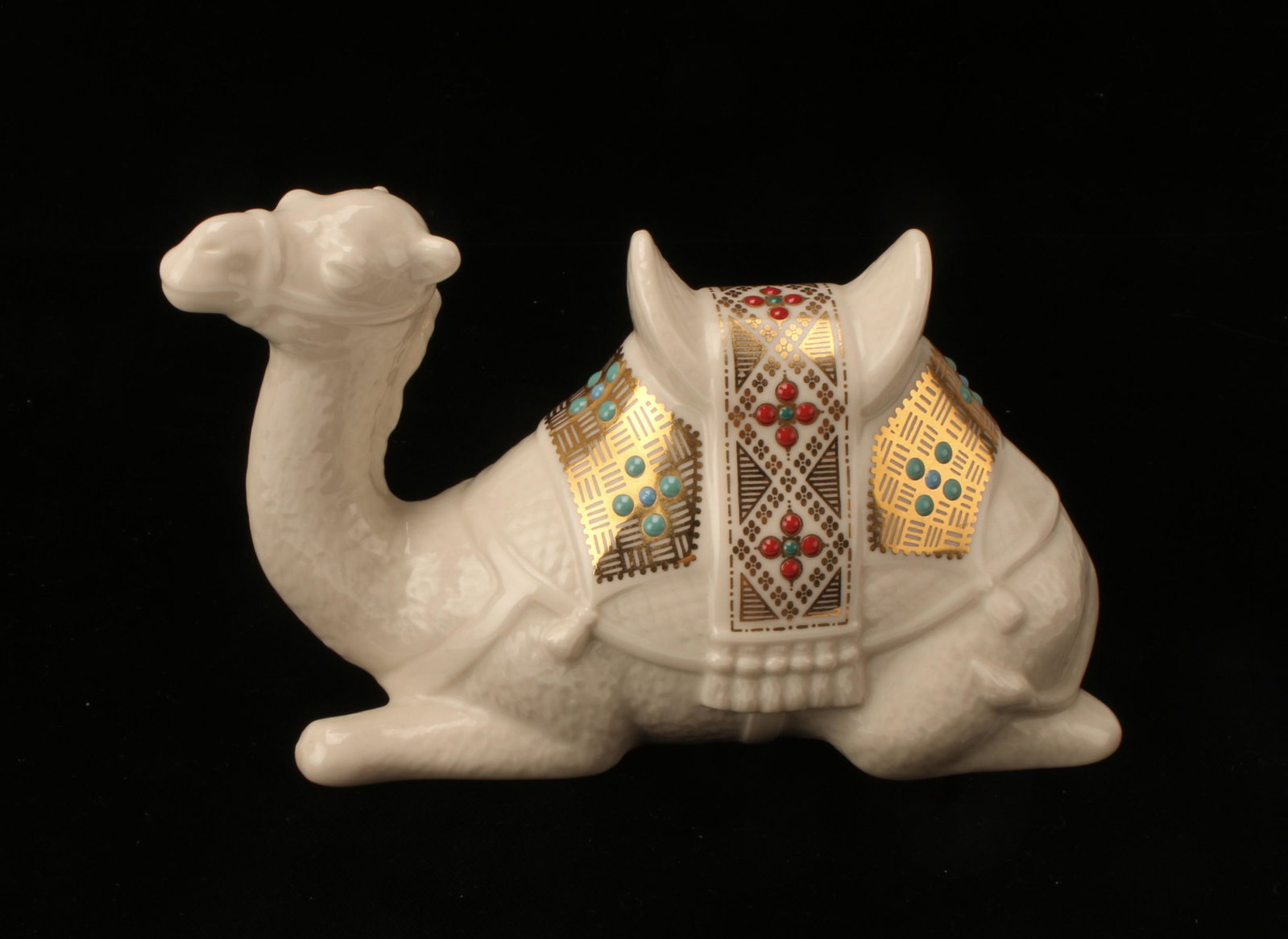 LENOX SEATED CAMEL FIGURINE: Jewel Collection 1994. "Jeweled" and gilded camel blanket on classic Lenox porcelain. 6" X 4" $40 - $80 Please contact us for high resolution images of this lot. Ship