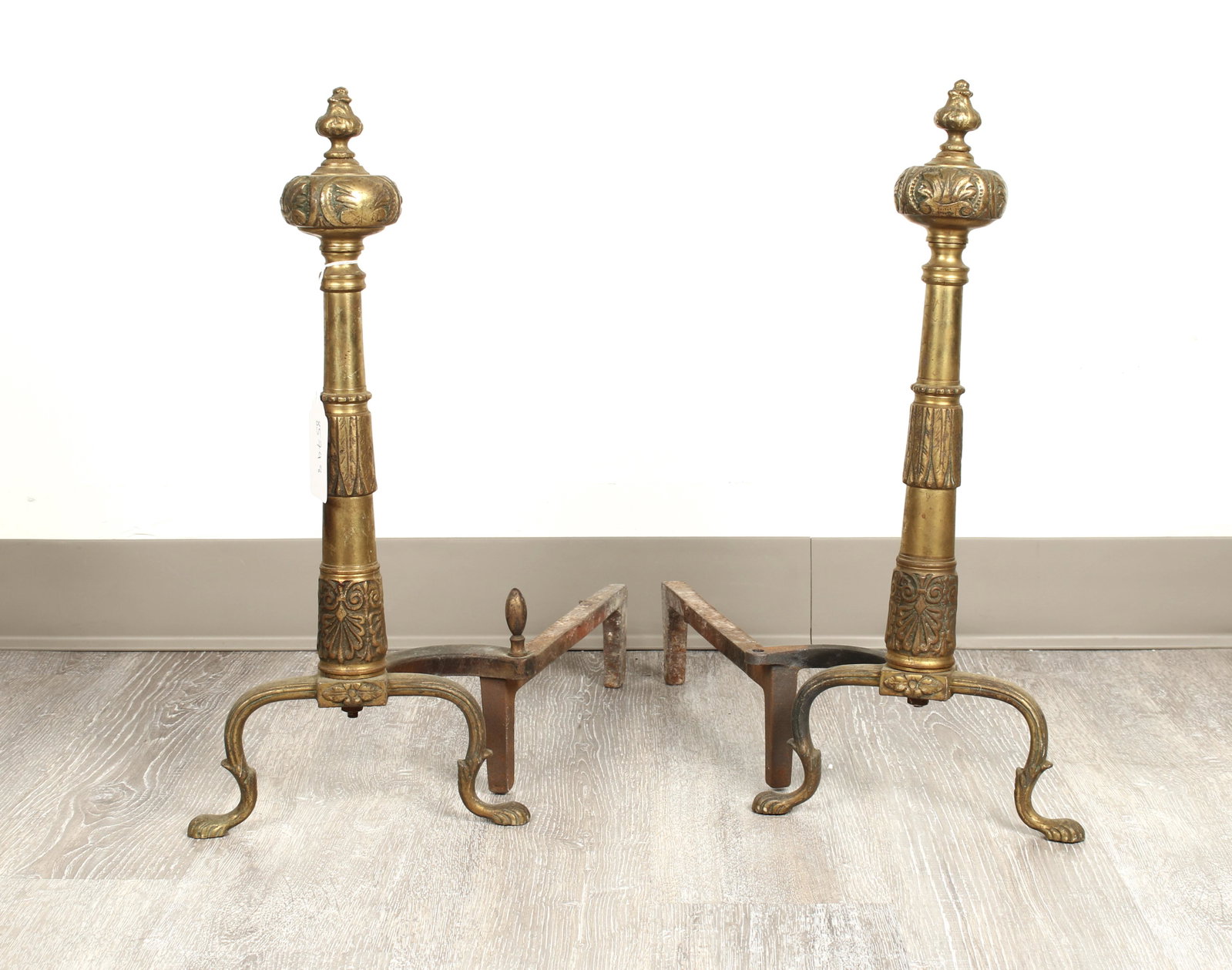 BRONZE COLUMNAR PAW FOOT ANDIRONS: With ball and bud finial. 20" x 19" x 9" $100 - $200 Please contact us for high resolution images of this lot. Shipping: We are unable to ship this