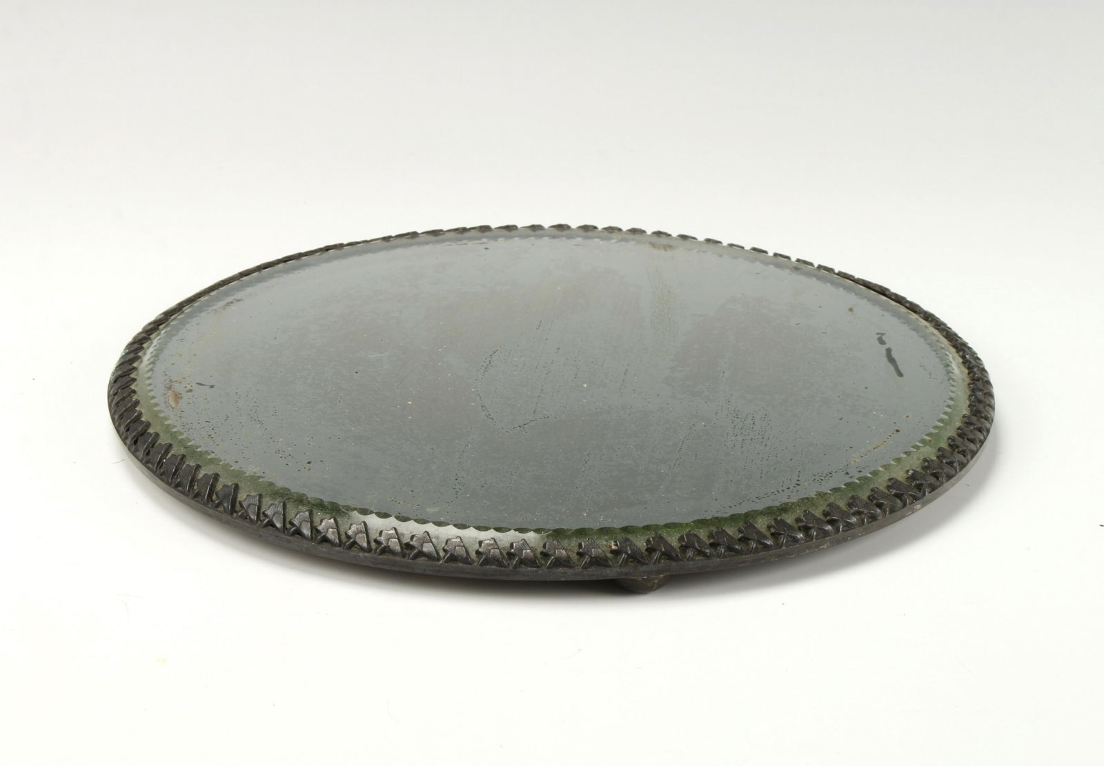 VINTAGE ROUND VANITY CENTERPIECE MIRROR: Faceted beveled glass on four round feet. Great for under a centerpiece or on a vanity with perfume bottles. 10" $40 - $80 Please contact us for high resolution images of this lot.