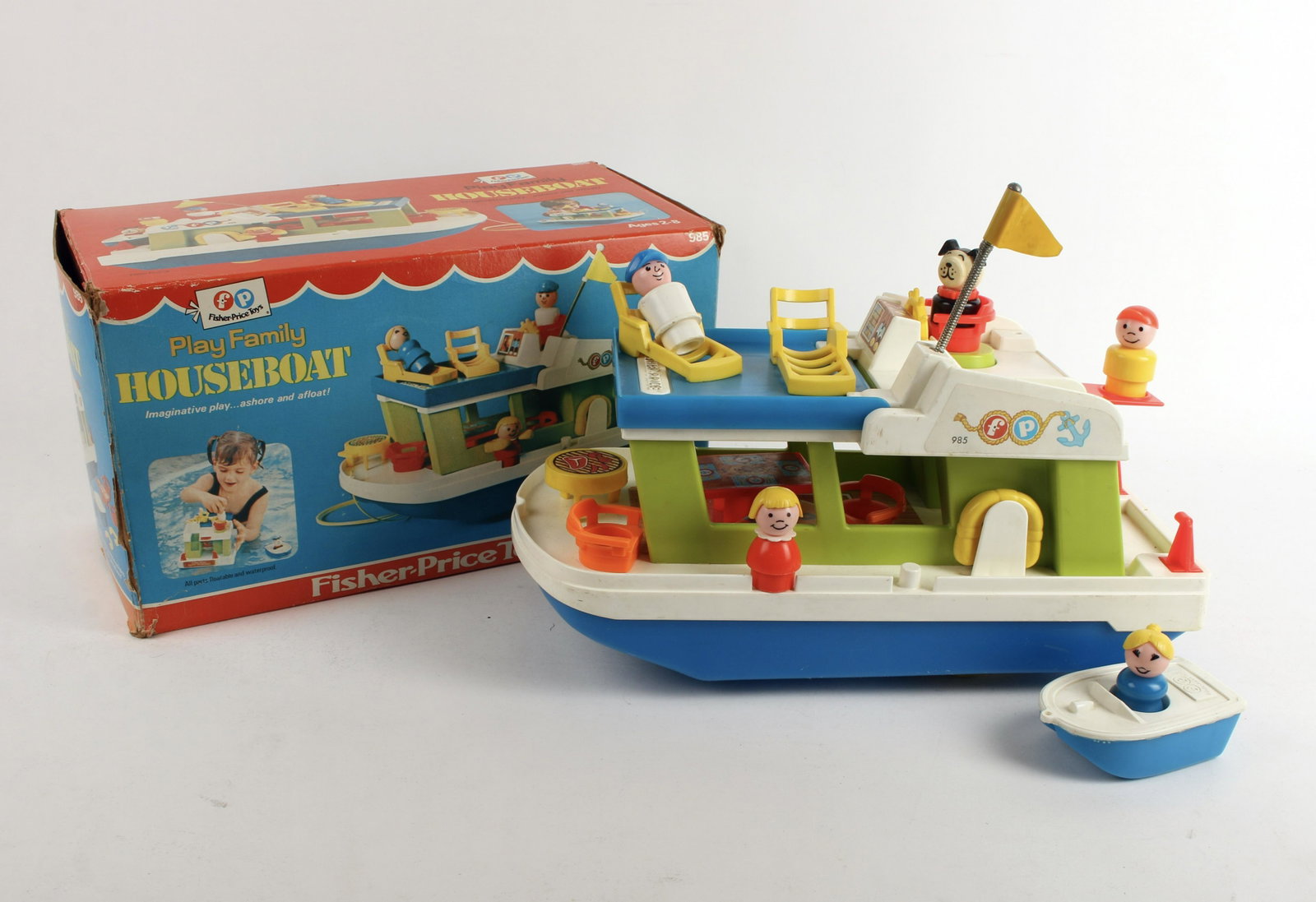 FISHER PRICE PLAY FAMILY HOUSEBOAT IN BOX 1972: Includes houseboat, 5 play family passengers, table and two chairs, barbecue grill and two deck lounge chairs, speedboat, and two life preservers. In box. To play on land, or in the water. No. 985. 13