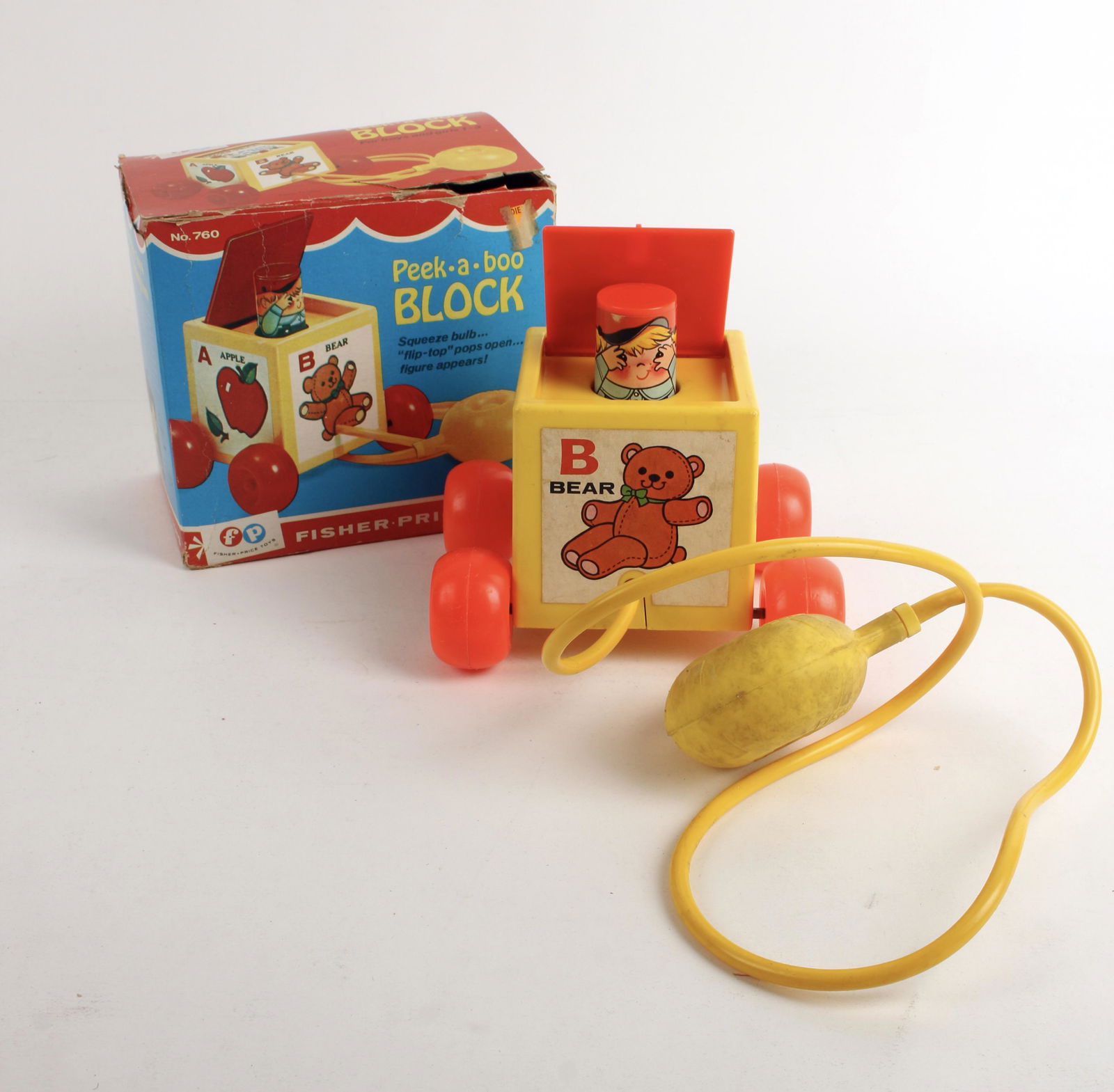 FISHER PRICE PEEK A BOO BLOCK IN BOX 1970: Peek-a-boo block pull toy on wheels in box. No. 760. 6" x 6" x 4 1/2" $40 - $80 Please contact us for high resolution images of this lot. Shipping: W