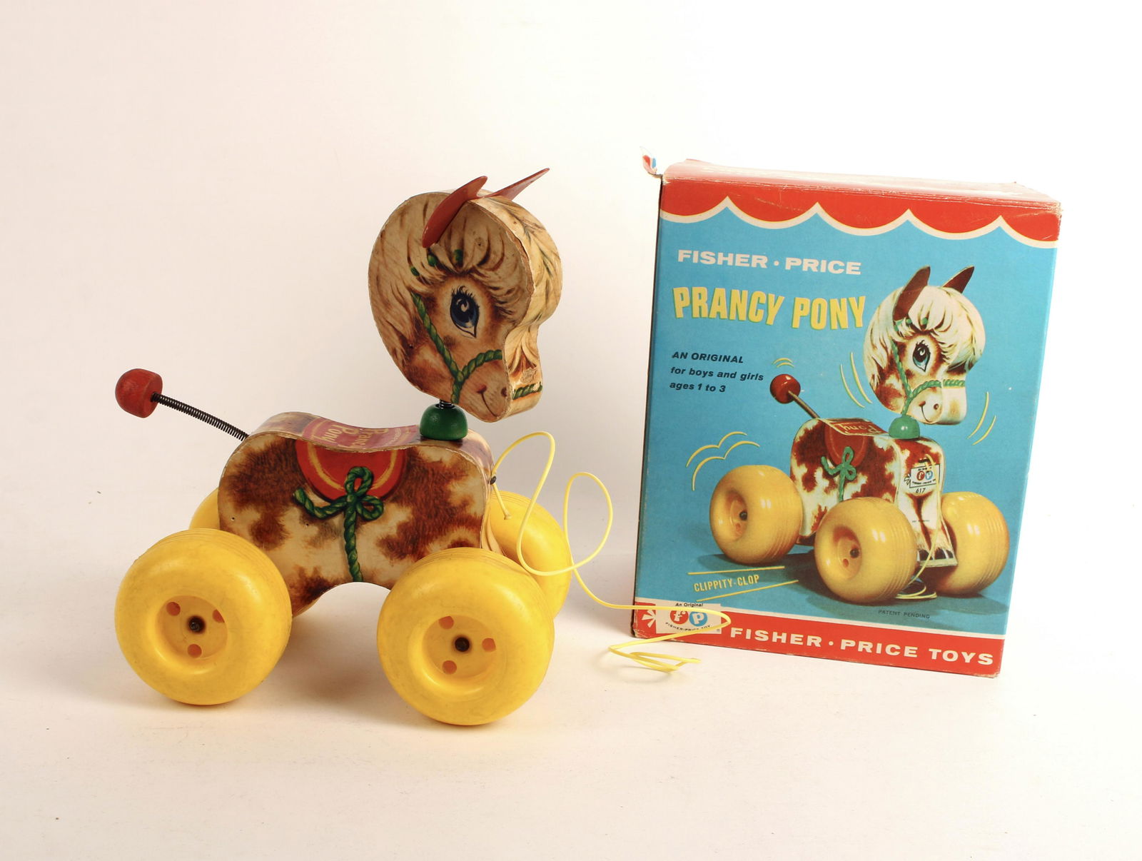 FISHER PRICE PRANCY PONY WITH BOX 1965: Horse pull toy with string. Pull to hear 'clippity-clop' sounds. Head and tail on springs for movement. No. 617. 8 1/2" x 6 1/2" x 5" $100 - $200 Please contact us for high resol