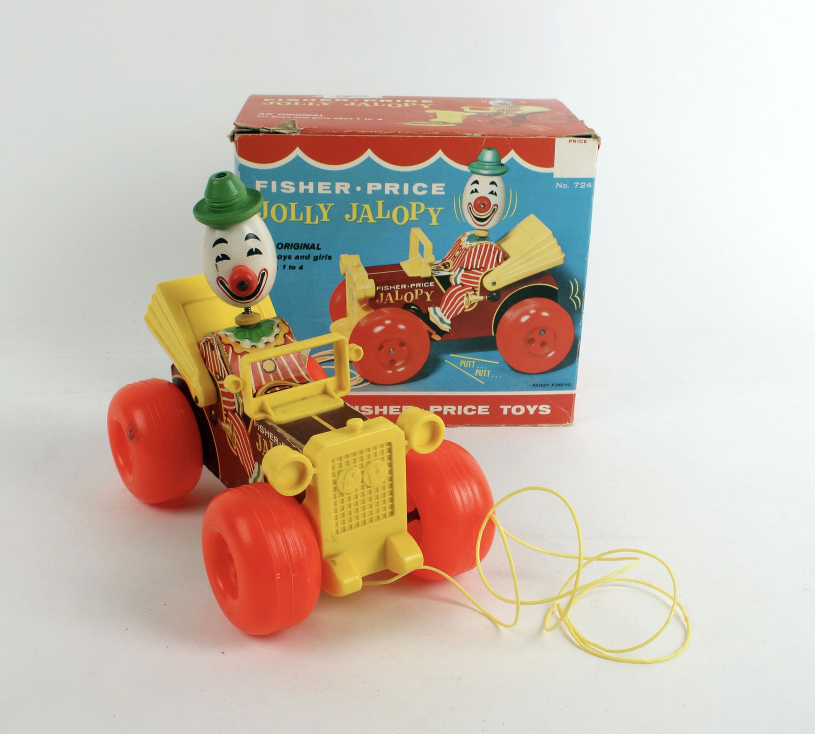 FISHER PRICE JOLLY JALOPY IN BOX 1965: Jalopy toy with pull string. Pull car along and watch it bounce up and down while making "putt putt' noises. Driver's head is on a spring for movement. No. 724. 7 1/2" x 6 1/2" x 4 1/2&