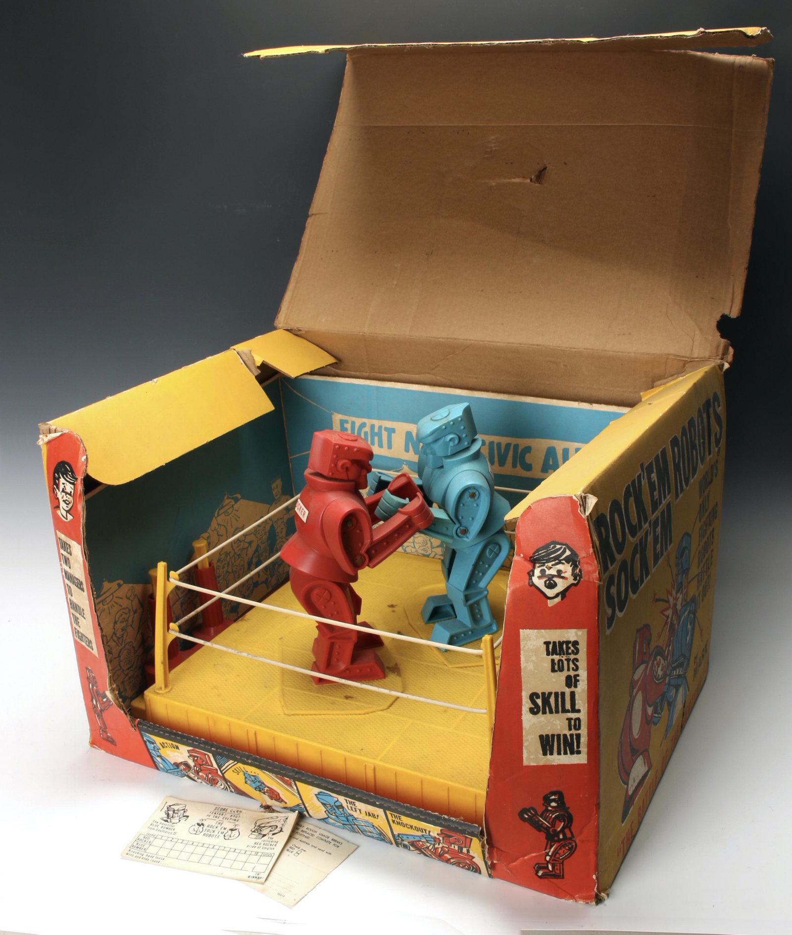 VINTAGE ROCK'EM SOCK'EM ROBOTS IN BOX MARX: With robots, ring, and arena scenery in box. Louis Marx Co. Inc., Erie, Pa. 20" X 14" X 13" $40 - $80 Please contact us for high resolution images of this lot. Shipping:</
