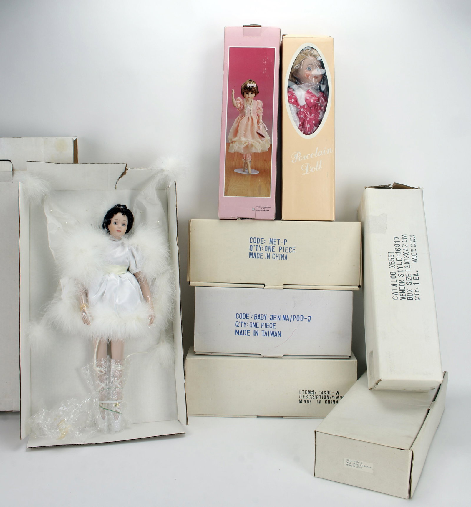 ASSORTED LOT EIGHT PORCELAIN DOLLS WITH BOXES: One ballerina from Swan Lake, one named Kimberly, one ballerina dressed in pink, one doll in pink polka dot dress, one 1950's blond in a poodle skirt, one harlequin in purple, one baby in pink, and tw