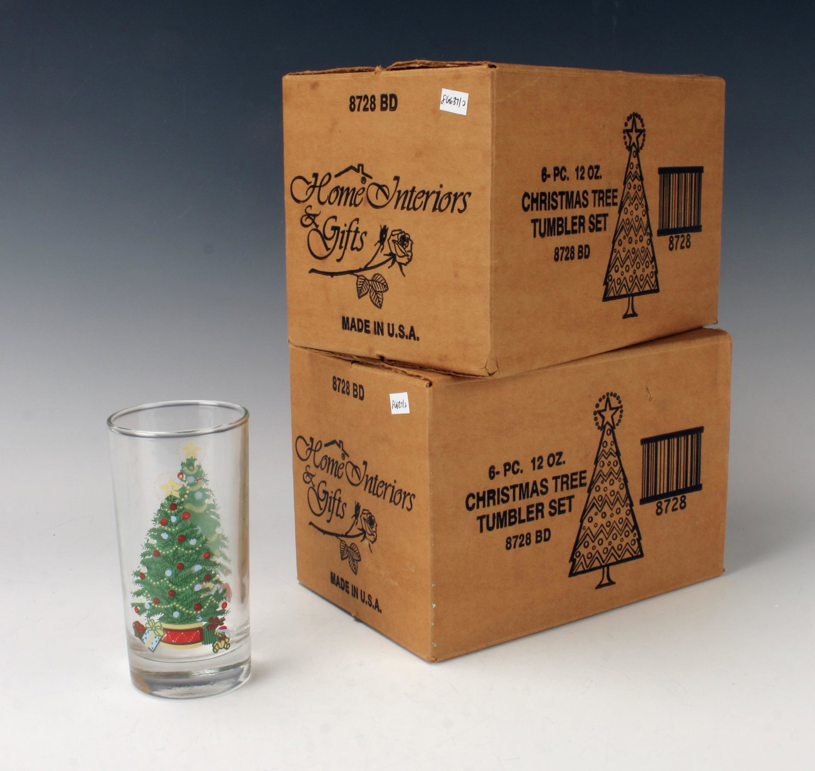 SET OF 12 CHRISTMAS TREE TUMBLERS GLASSES IN BOX: In original boxes. These 12oz glasses are decorated in colorful Christmas trees and presents. With six 12oz glasses in each box. 6" X 8 3/4" $40 - $80 P