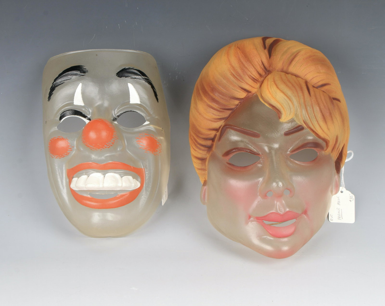 TWO VINTAGE FRENCH CLEAR MASKS BARDOT & CLOWN: Halloween is just around the corner! One that looks like Brigitte Bardot is marked French, the clown mask is not marked. Both are made of translucent plastic. 9 12" X 7" $100 - $200 P