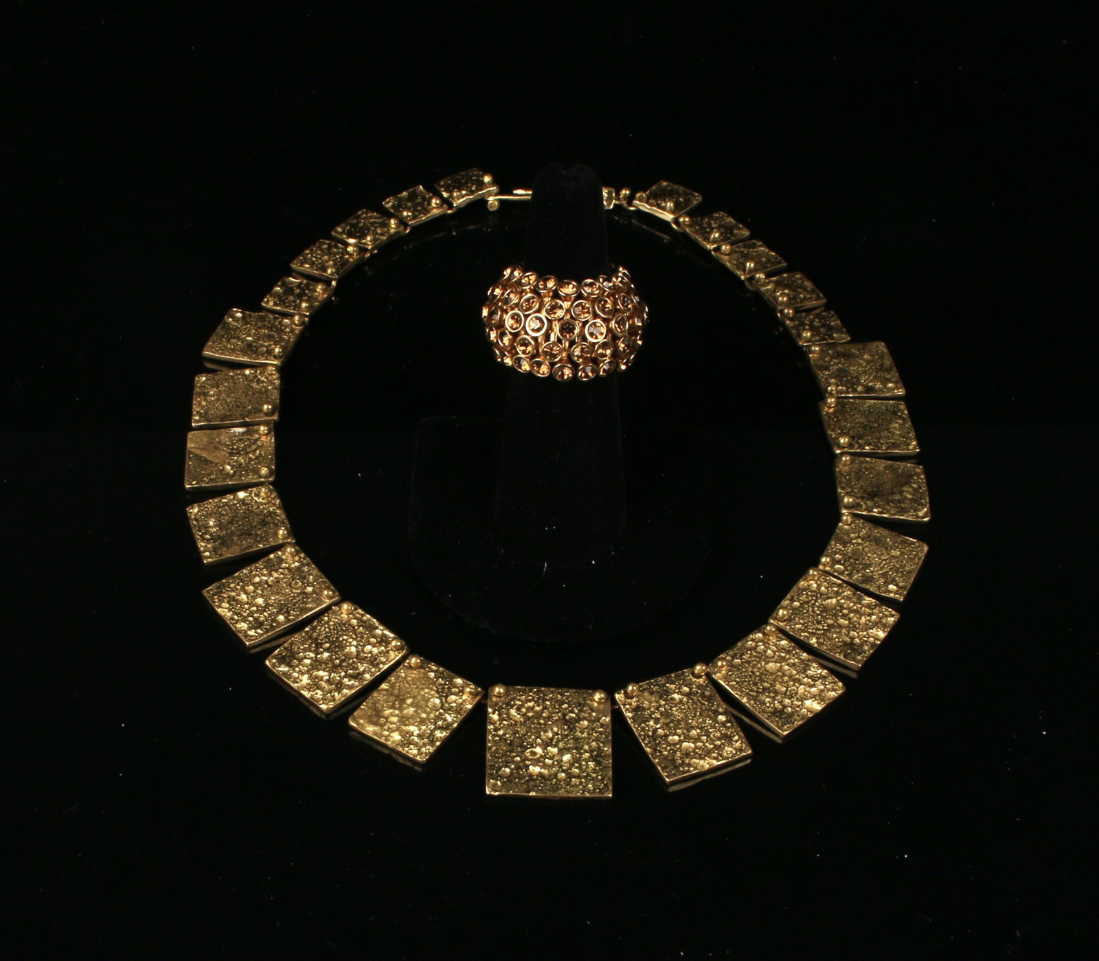 SIGNED MID CENTURY BRUTALIST CHOKER: Mid century Brutalist graduated hammered gold square choker signed Anne Dick. Also included is a Sputnik ring gold tone with faceted amber colored stones, ring stretches to fit many sizes. Provenance: