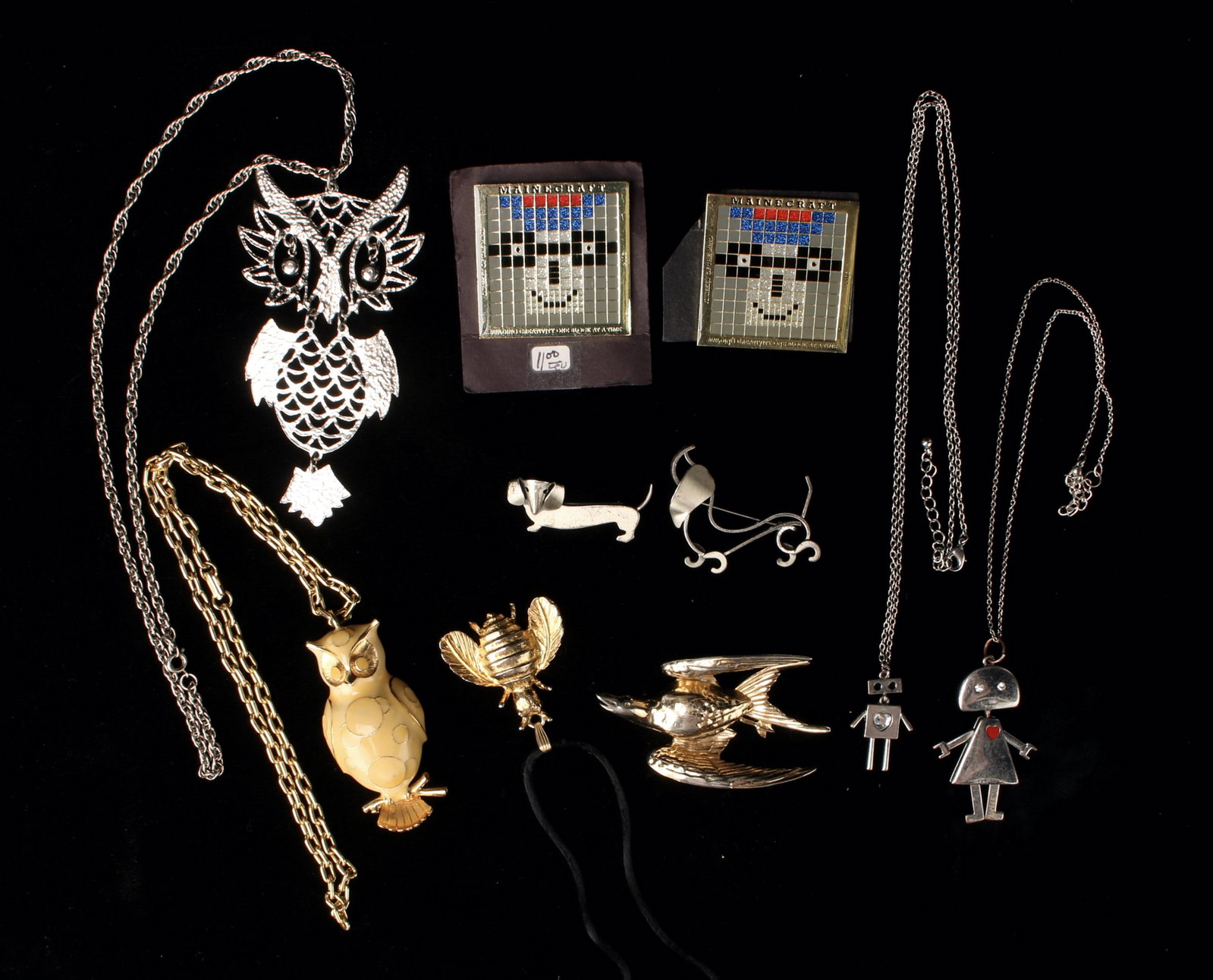 LOT OF VINTAGE COSTUME FIGURAL PINS & PENDANTS: Figural Pendants and Pins, including two vintage sterling stylized dachshund pins, Robot pendants, two Maincraft pins, two figural owl pendants, gold bee, and a large swallow pin. Provenance: Major NY