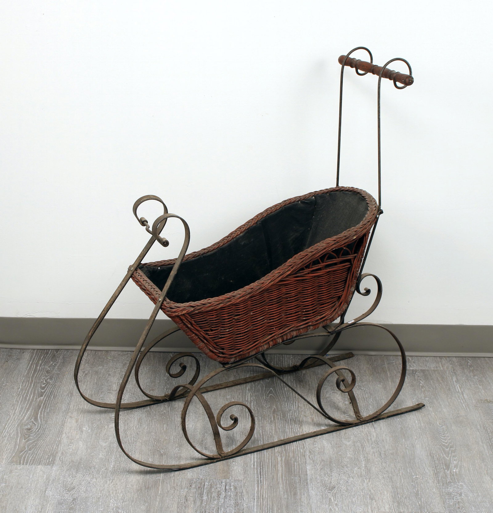 ANTIQUE VICTORIAN WICKER DOLL SLEIGH: With wrought iron runners and wicker sleigh body. Heavy fabric lining. 33" X 12 1/2" X 36 1/2" $40 - $80 Please contact us for high resolution images of this lot. Shipping