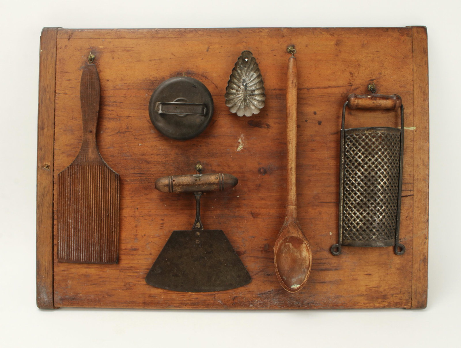 ANTIQUE BREAD BOARD W PRIMITIVE KITCHEN TOOLS: This bread board has been used as a backdrop for a variety of circa 1900 kitchen utensils. 22" X 16" $40 - $80 Please contact us for high resolution images of this lot. Shippin