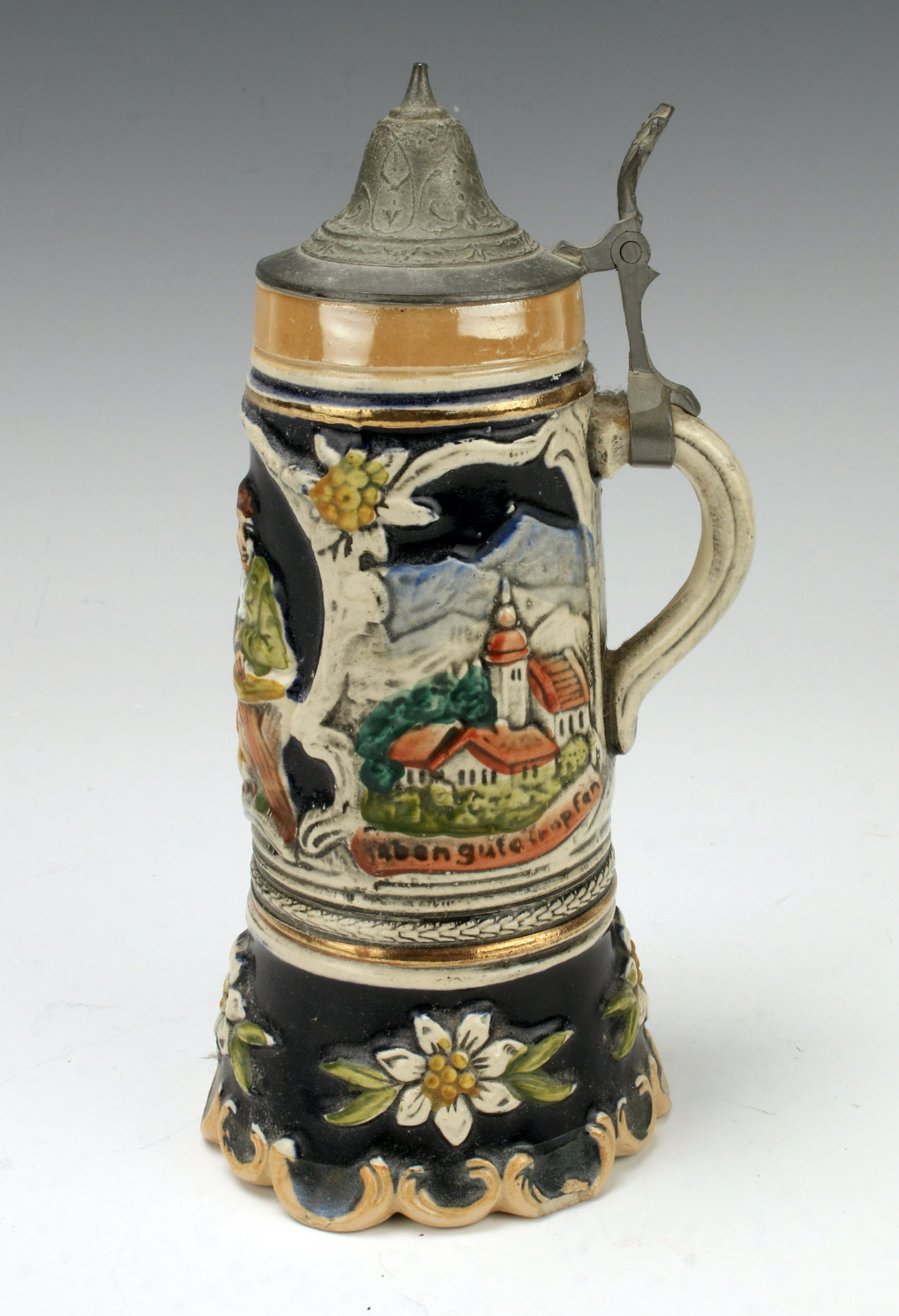GERMAN MUSIC BOX BEER STEIN: The music stops when you set the stein down- you only get rewarded with music while you hold it aloft! In luster glaze with scenes of a tavern and two towns labeled Gersthofen and Abengute Bronpfen. A