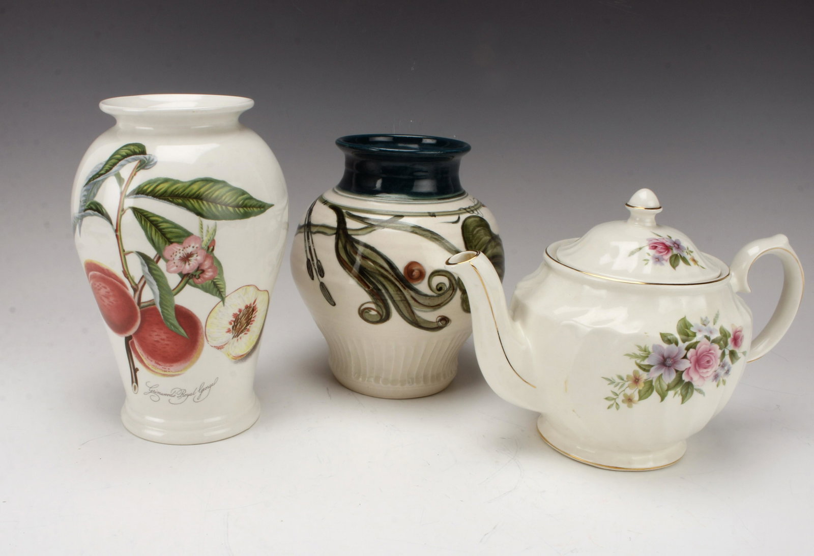 POMONA PORTMEIRON VASE, WINDSOR ENGLISH TEAPOT: Assembled lot of three pieces of porcelain: Pomona Portmeiron vase with "Grimwoods Royal George" peaches design, Hand painted cattails vase, and Windsor English teapot with delicate floral d