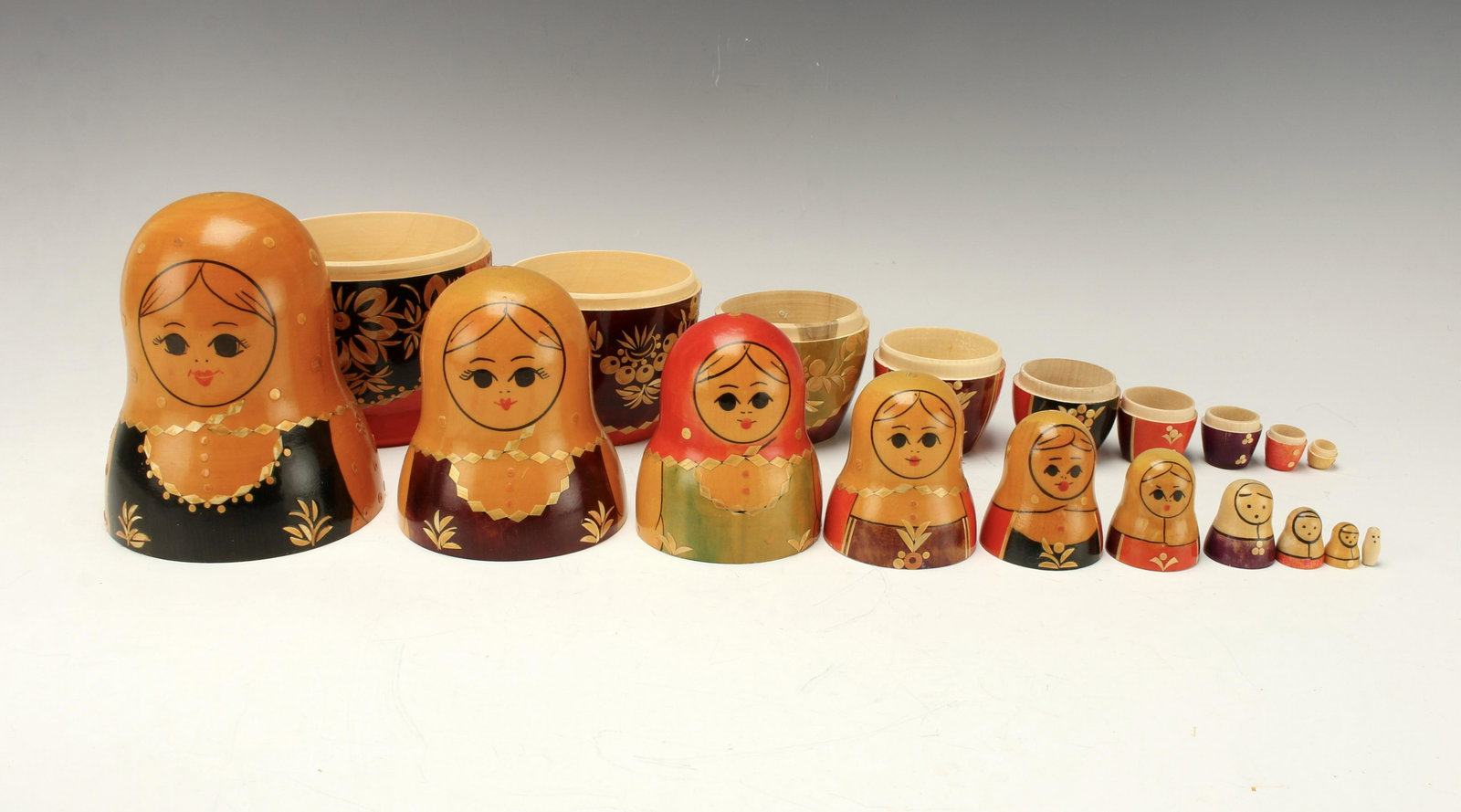 HAND PAINTED RUSSIAN MATRYOSHKA NESTING DOLLS: Ten dolls in one, all women hand painted with folk art designs on cut out straw. Paper seal with USSR and artist's number on bottom of largest piece. 5" X 9" $20 - $40 Please contact