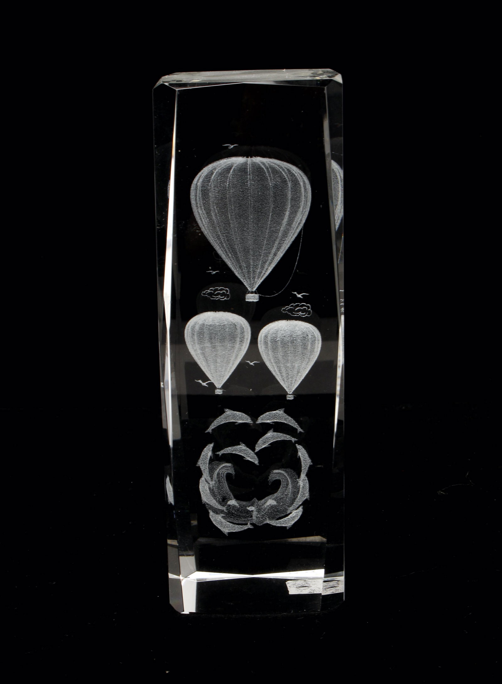 DOLPHINS & HOT AIR BALLOONS ETCHED PAPERWEIGHT: Heavy 3D laser etched glass paperweight reveals dolphins spiraling under clouds, birds, and hot air balloons. For dreamy contemplation. 2" X 6" $20 - $40 Please contact us for high res