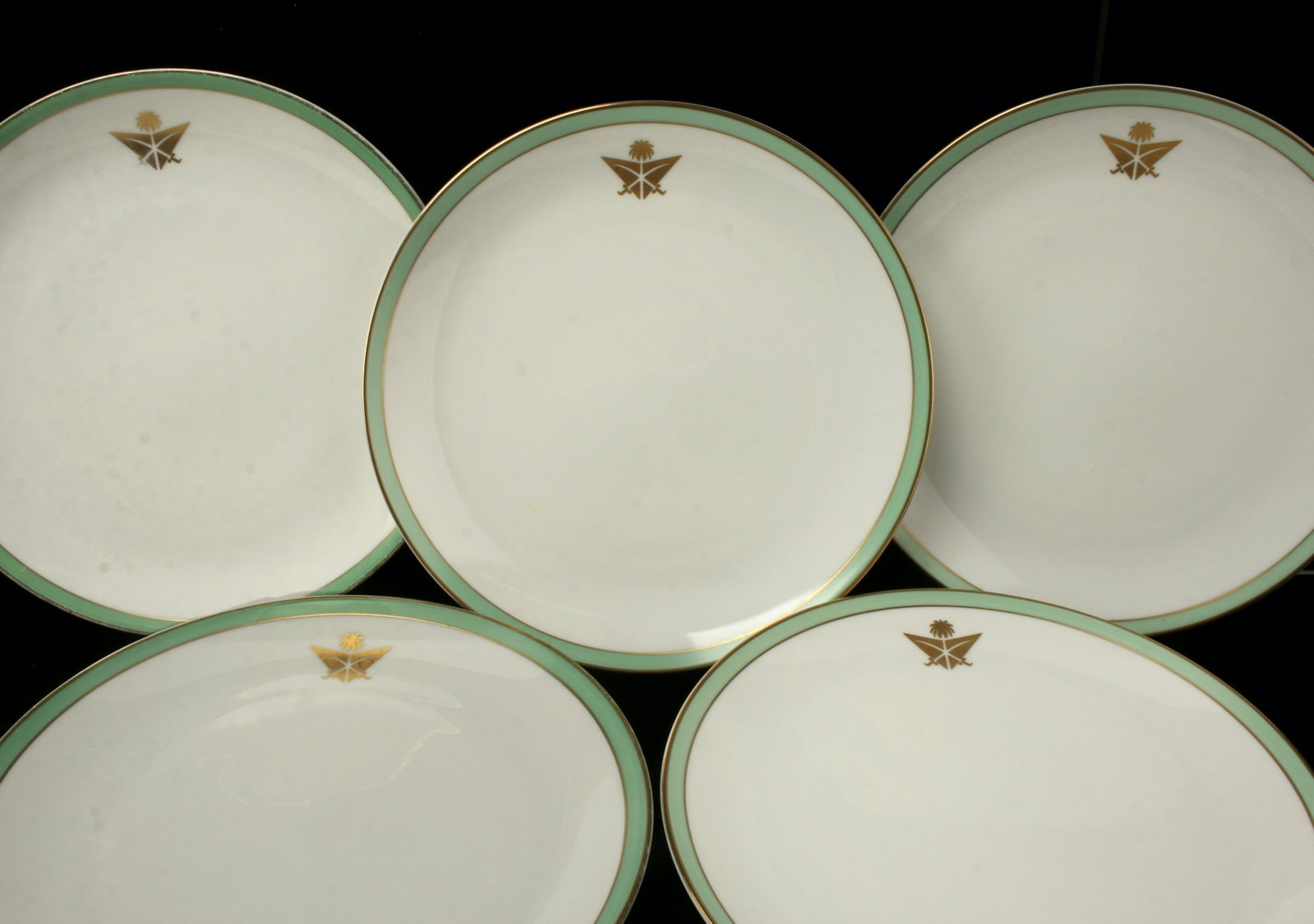 10 ROSENTHAL SAUDI ARABIAN AIRLINES PLATES: Ten Rosenthal plates made for Saudi Arabian Airlines 1st class service. Green border with gold edging and gold Saudi Arabian seal. Circa 1960s-1970s. Marked on bottom "Special Design for Saudi Ar