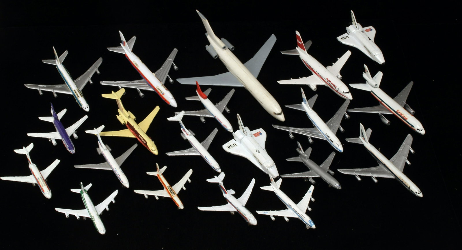 ASSORTED LOT MODEL AIRPLANES: Including American, FedEx, United, Eastern, People Express, Pan Am, Northwest Orient, Delta, TWA, Continental, Piedmont, Alitalia, and US shuttle. Including some pieces of wings and wheels. 9" X 