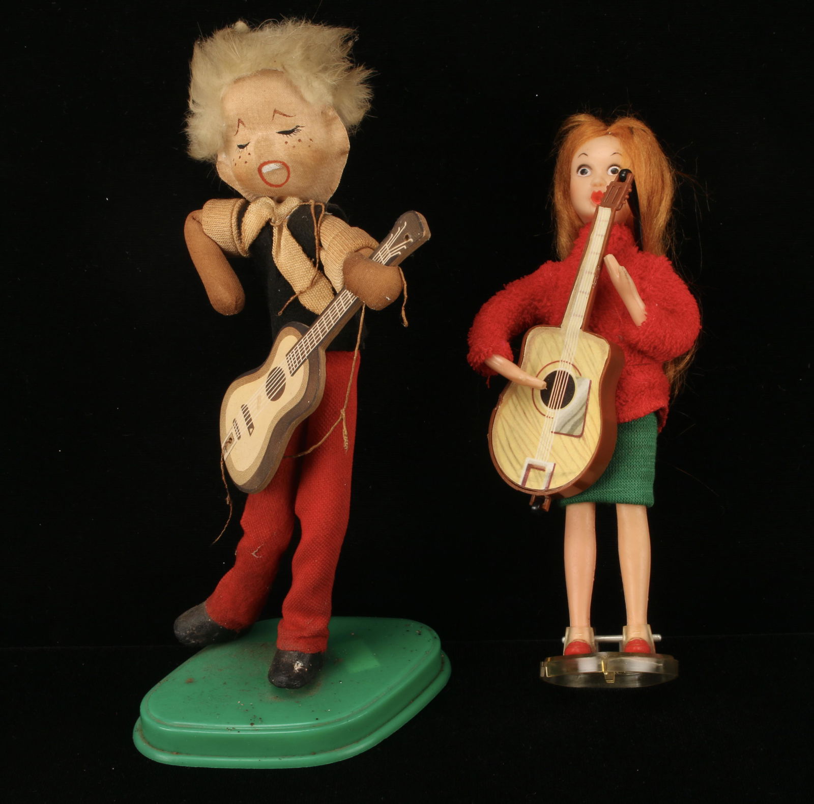 2 GROOVY BOY & GIRL MUSICIAN DOLLS 1965: The girl "Beat" musician doll wearing a turtleneck and carrying a guitar is plastic and marked Delux Reading Co, 1965. The groovy guy is stuffed cloth and has a molded hand painted face and