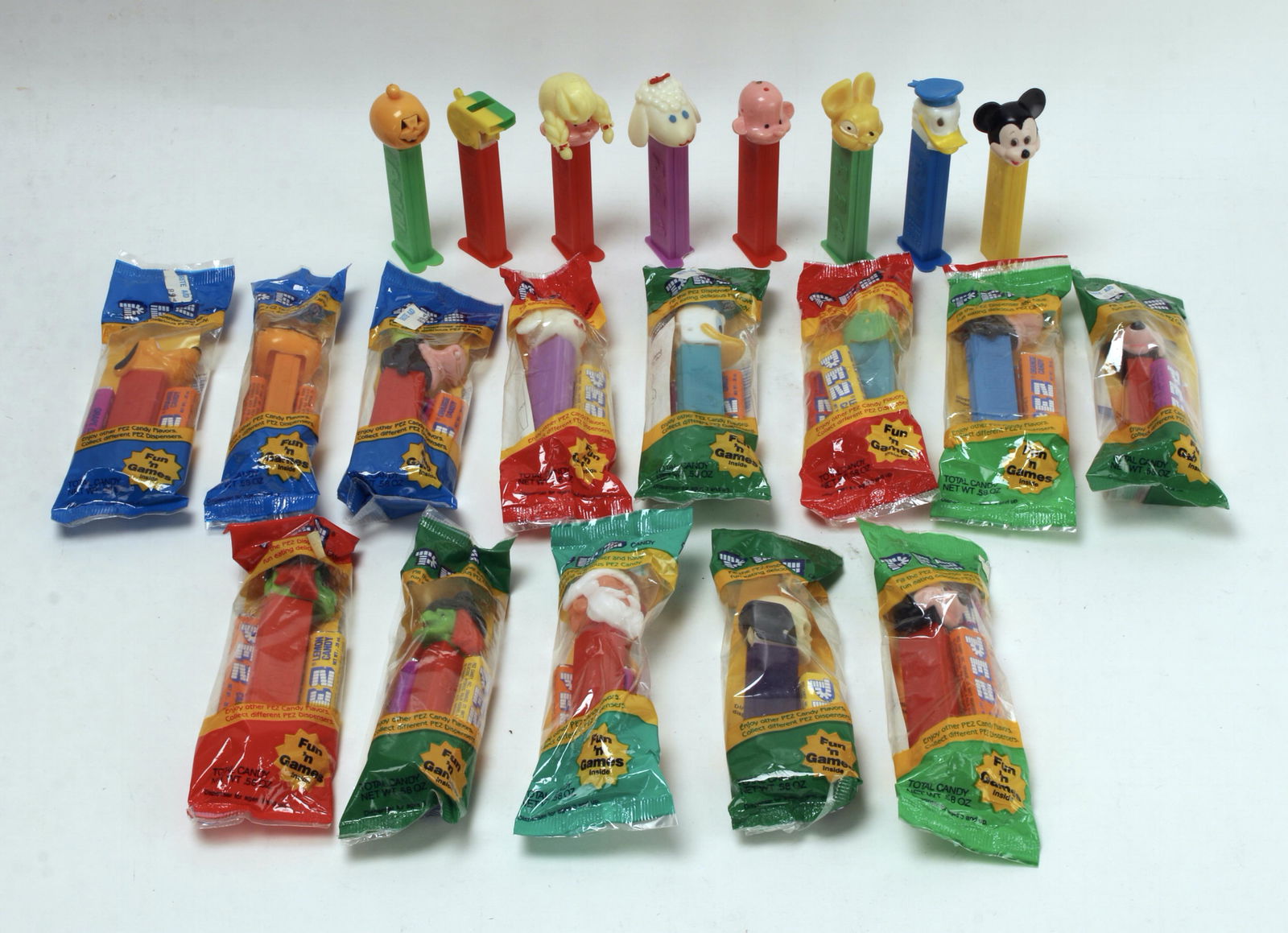 ASSORTED LOT PEZ DISPENSERS USED & NEW: Some used, many new in packaging. Including Disney characters, Santa, Halloween themed characters, Garfield, storybook characters, and more. 4" $40 - $80 Please contact us for high resolut