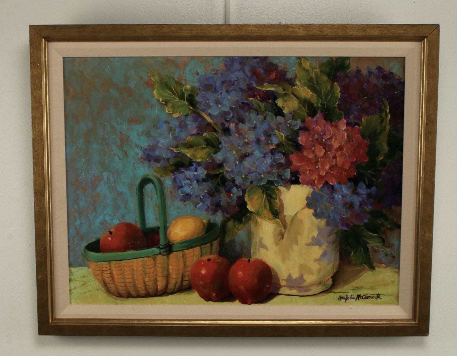 MCCORMACK STILL LIFE OF HYDRANGEAS AND FRUIT: Ana Delia McCormack painting of hydrangeas in a pitcher near apples and lemons in a basket. 28 1/2" X 22" $100 - $200 Please contact us for high resolution images of this lot. S