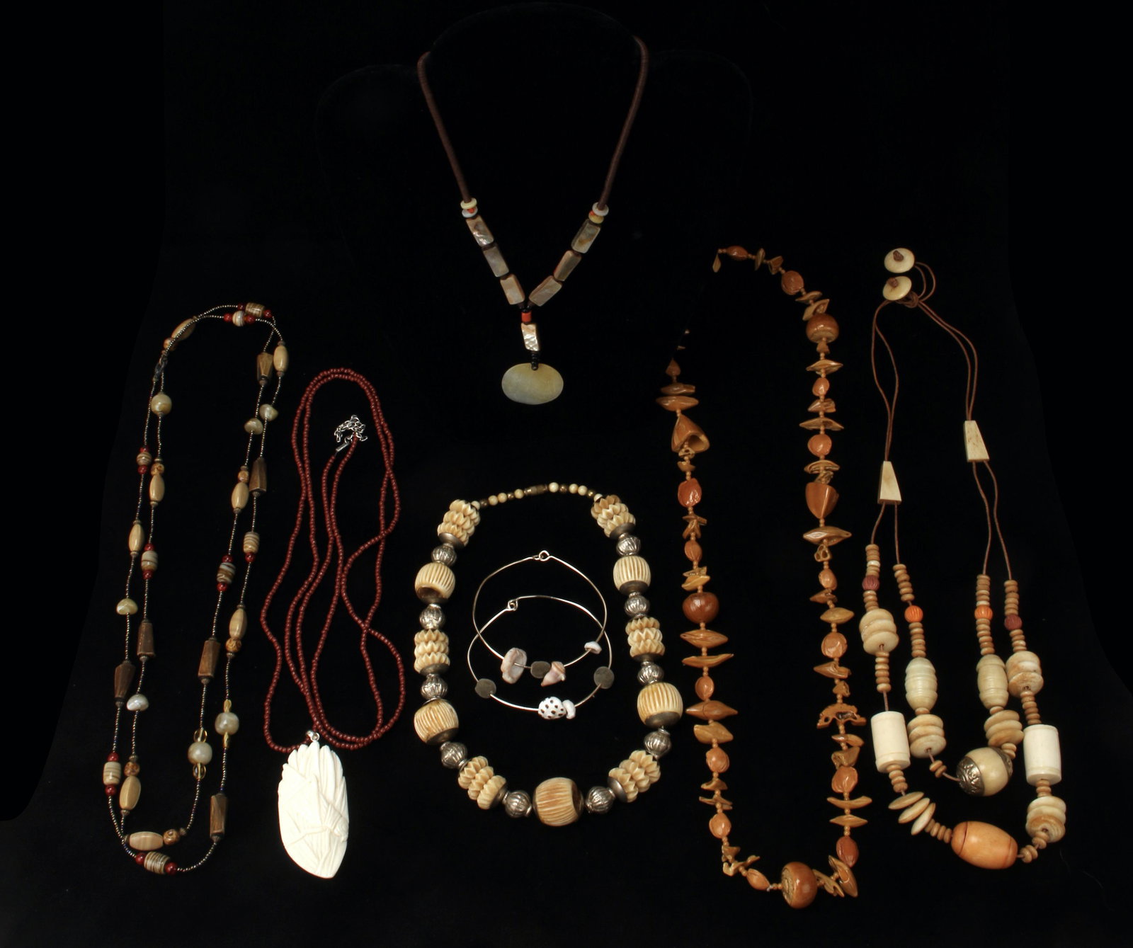 TRIBAL JEWELRY LOT: 6 necklaces and 2 bracelets of assorted carved wooden, bone, mother of pearl, glass and shell beads. Wonderful textures and subtle earth-tone colors. Provenance: Major NYC fashion and antiques collect