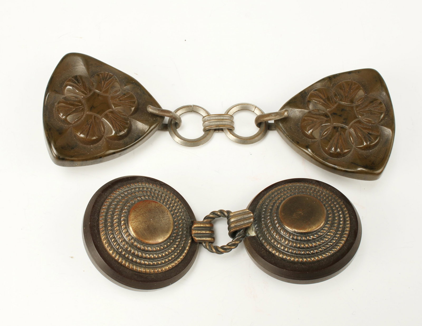 VICTORIAN SETS HOOK AND EYE CLOAK CLASP FASTENERS: 2 sets of cloak fasteners. One set on round bakelite backs with copper centers of cencentric rope patterns, the other set triangular shaped bakelite flower forms with metal hook and eye closures..