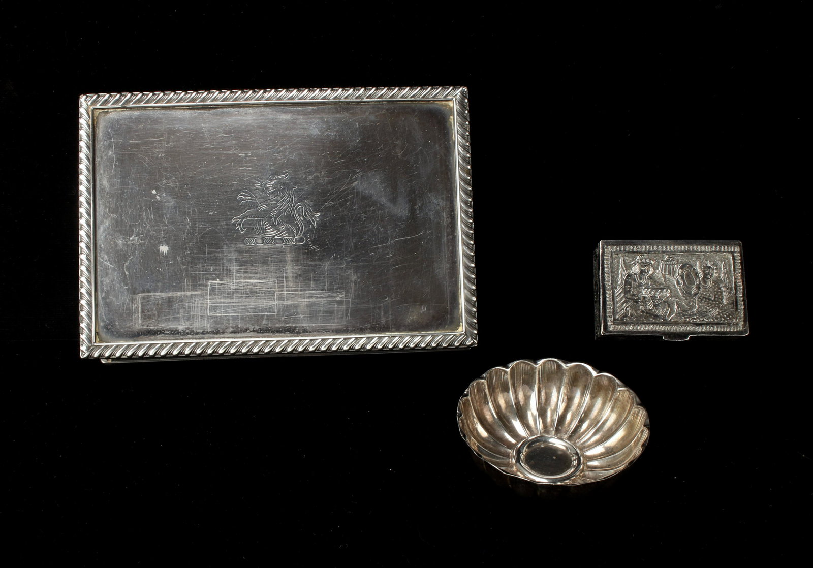 ASSEMBLED LOT OF SILVER ITEMS: Pill box, nut bowl, and trinket box. Hallmarked on both boxes, nut bowl is marked sterling. Larger box engraved with Col. Momo Aug. 18 1940. 5 1/2" x 3 1/2" x 1 1/2" $100 - $200