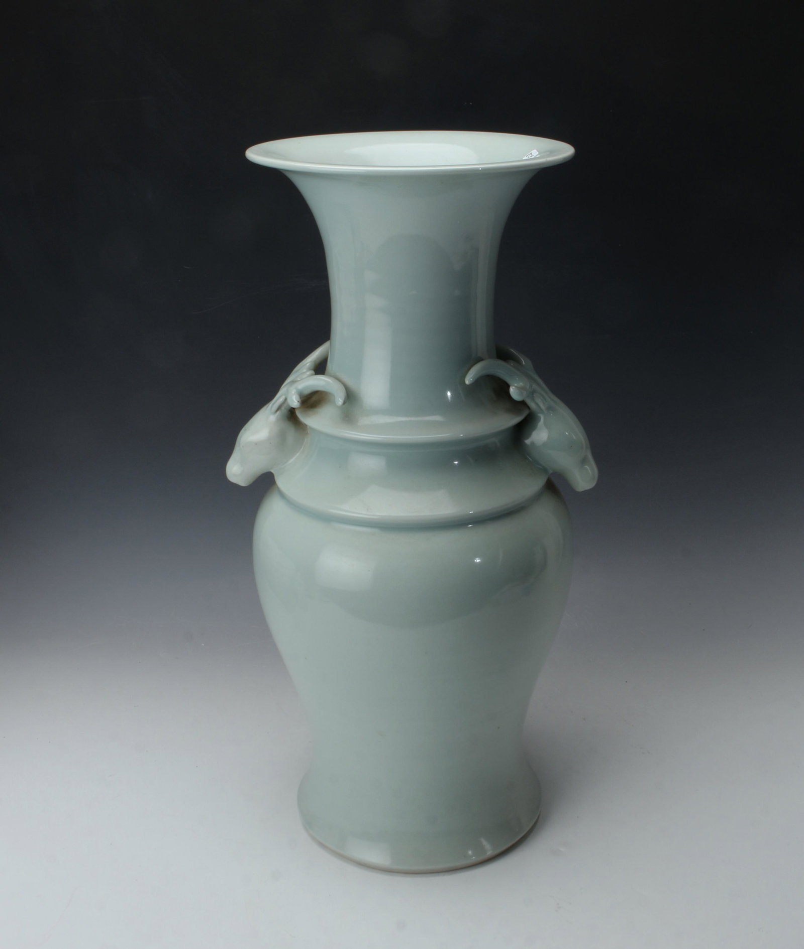 19TH C. IMPRESSIVE SIZED CHINESE STAG HANDLE VASE: Stag head handles and defined ridges at the shoulders. Glazed in celadon all over. Provenance: private collection.