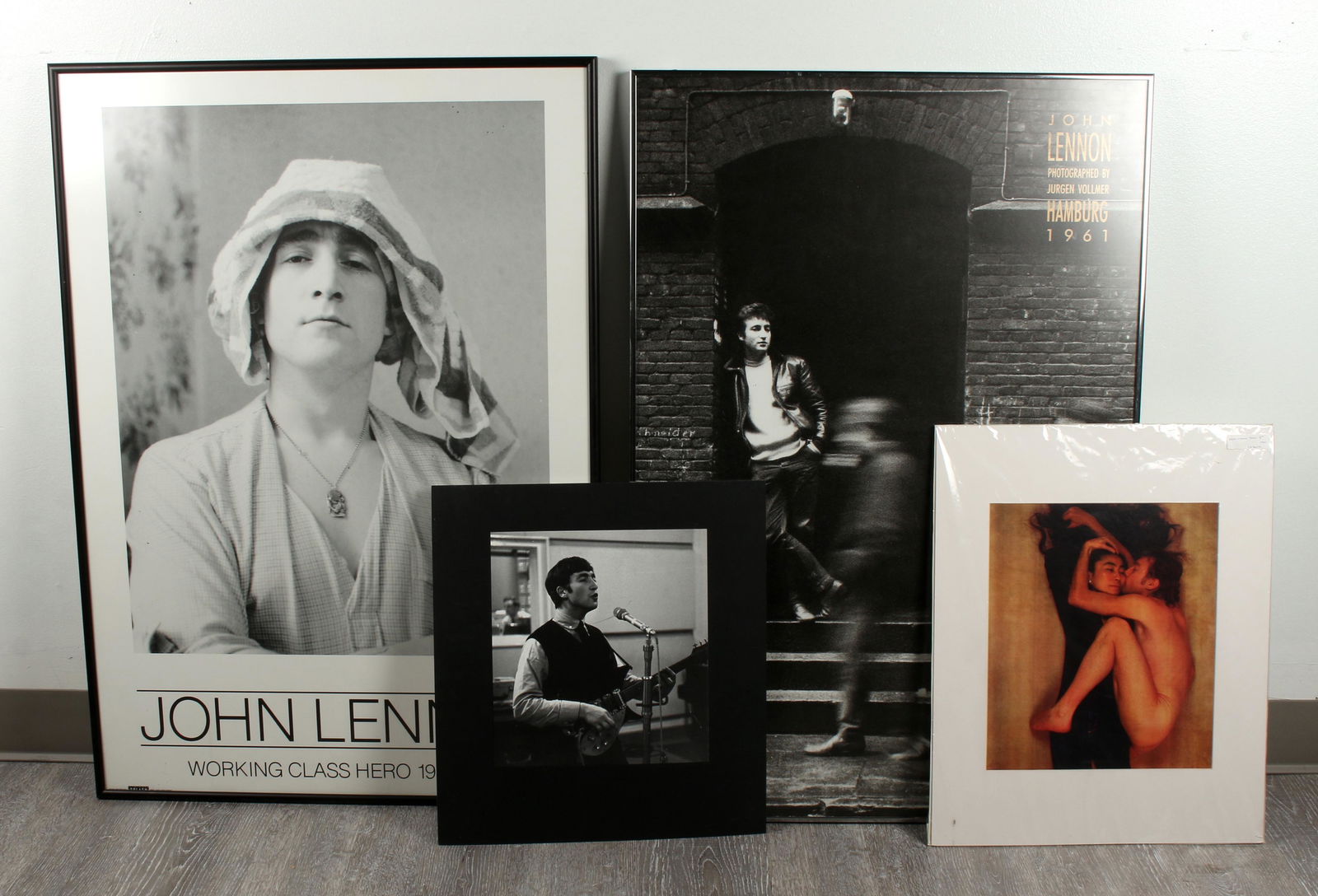 4 THE BEATLES JOHN LENNON PRINTS POSTERS: One is Lennon Working Class Hero poster, the other is a poster of the photograph by Jurgen Vollmer Hamburg 1960 of John in a doorway, one matted unframed print is an iconic John and Yoko photo, the ot