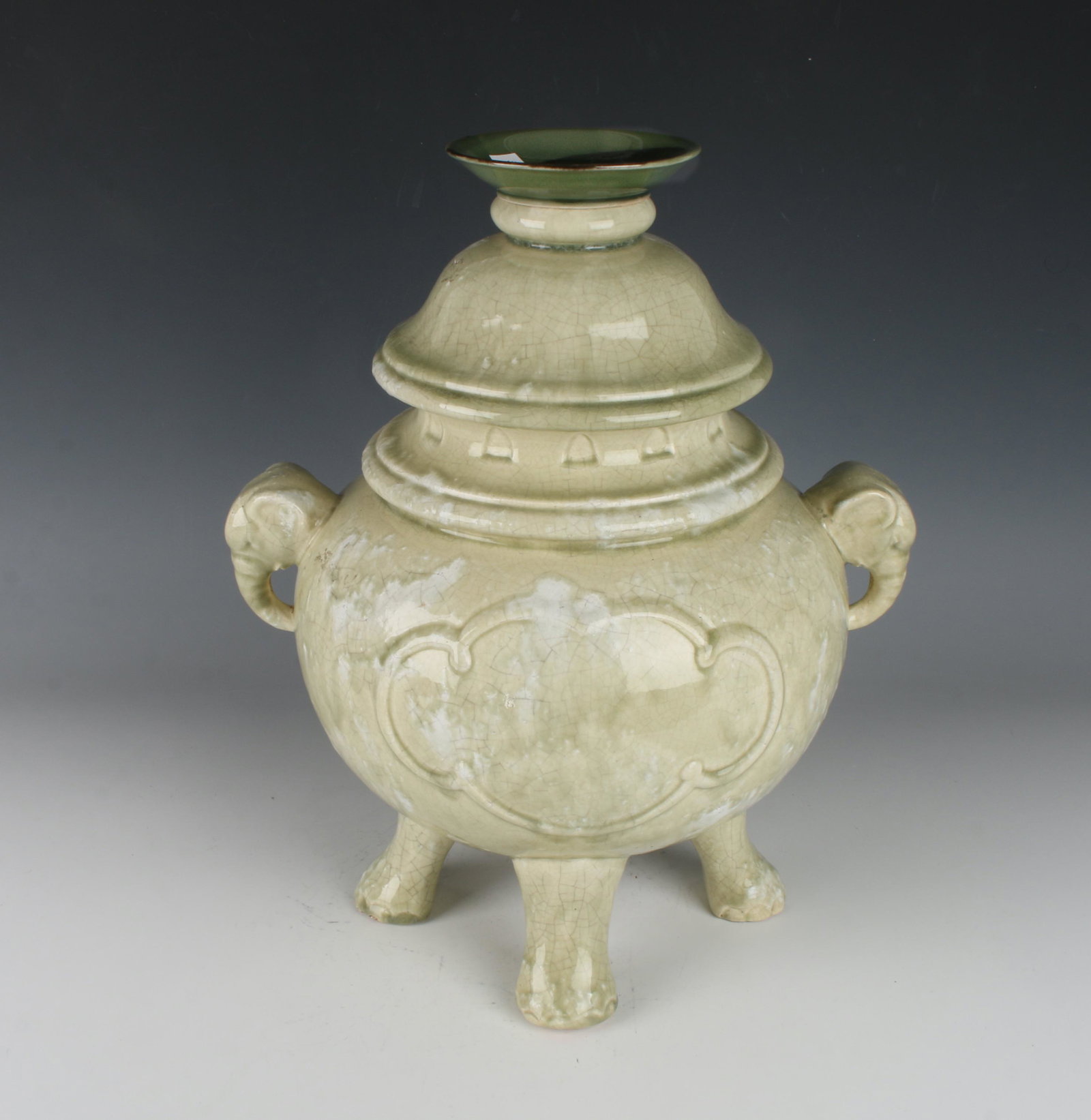 LARGE CRACKLE CENSER FORM: Elephant head handles and four elephant foot feet. Pale celery green with white cloud accents. The top has a small dish as a finial. 16" X 13" $300 - $500 Please contact us for high r