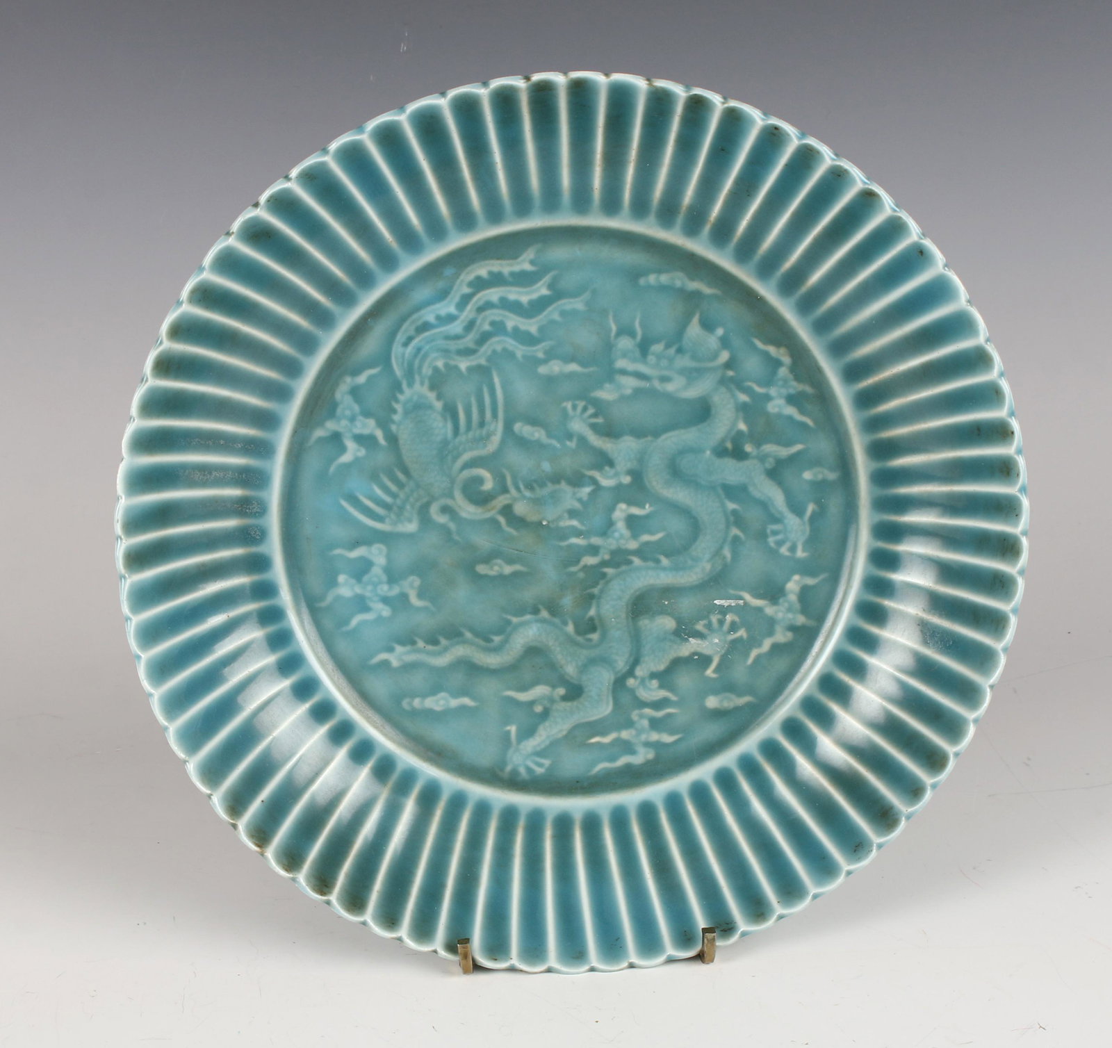 TEAL SCALLOPED EDGE DRAGON PHOENIX BOWL: Facing dragon and phoenix in the center in flaming clouds with a scalloped edge. Marked on the bottom. 9" x 2" $200 - $400 Please contact us for high resolution images of this lot.