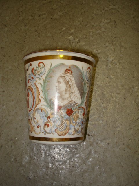 Qneen Victoria enamel beaker: A 4" enamel beaker commemorating the coronation of Queen Victoria in 1837, with polychrome transfer decorations.