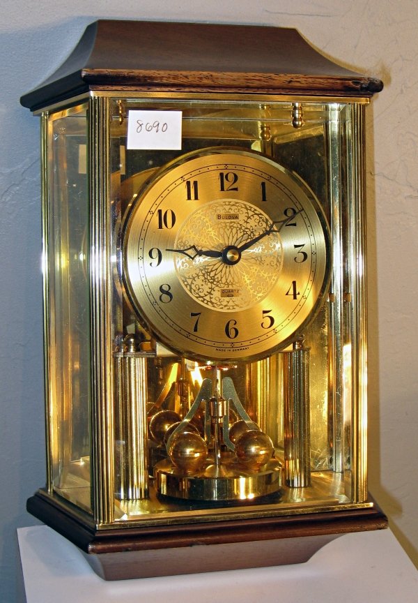 Bulova wall clock with rotating pendulum.: Bulova wall clock with rotating pendulum.