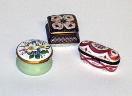 Three reproduction enamel patch boxes: Three reproduction enamel patch boxes, including one marked with crossed arrows numbered 44/89.