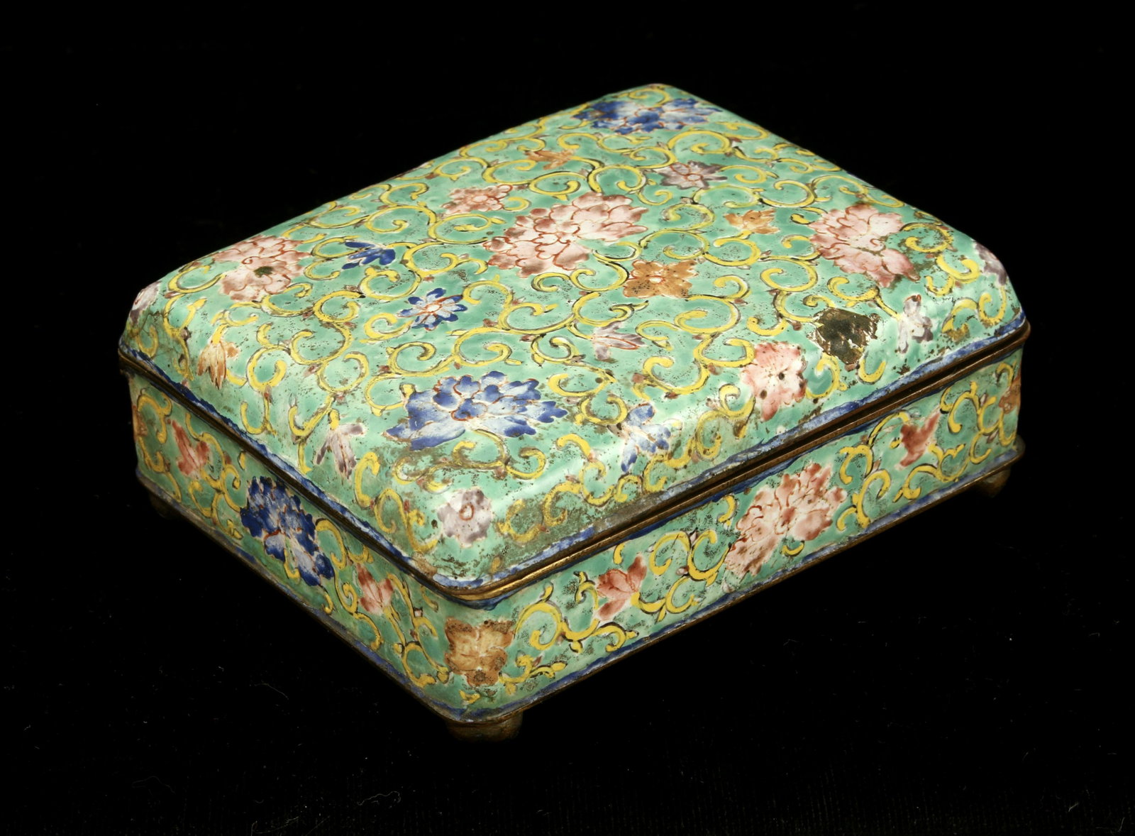 ANTIQUE FINELY ENAMELED FLORAL BOX: Four rounded feet. Green background with yellow tendrils, and blue and pink blossoms. Turquoise enamel interior and bottom. Provenance: From the collection of a premier antiques collector, Dr. M. V. S