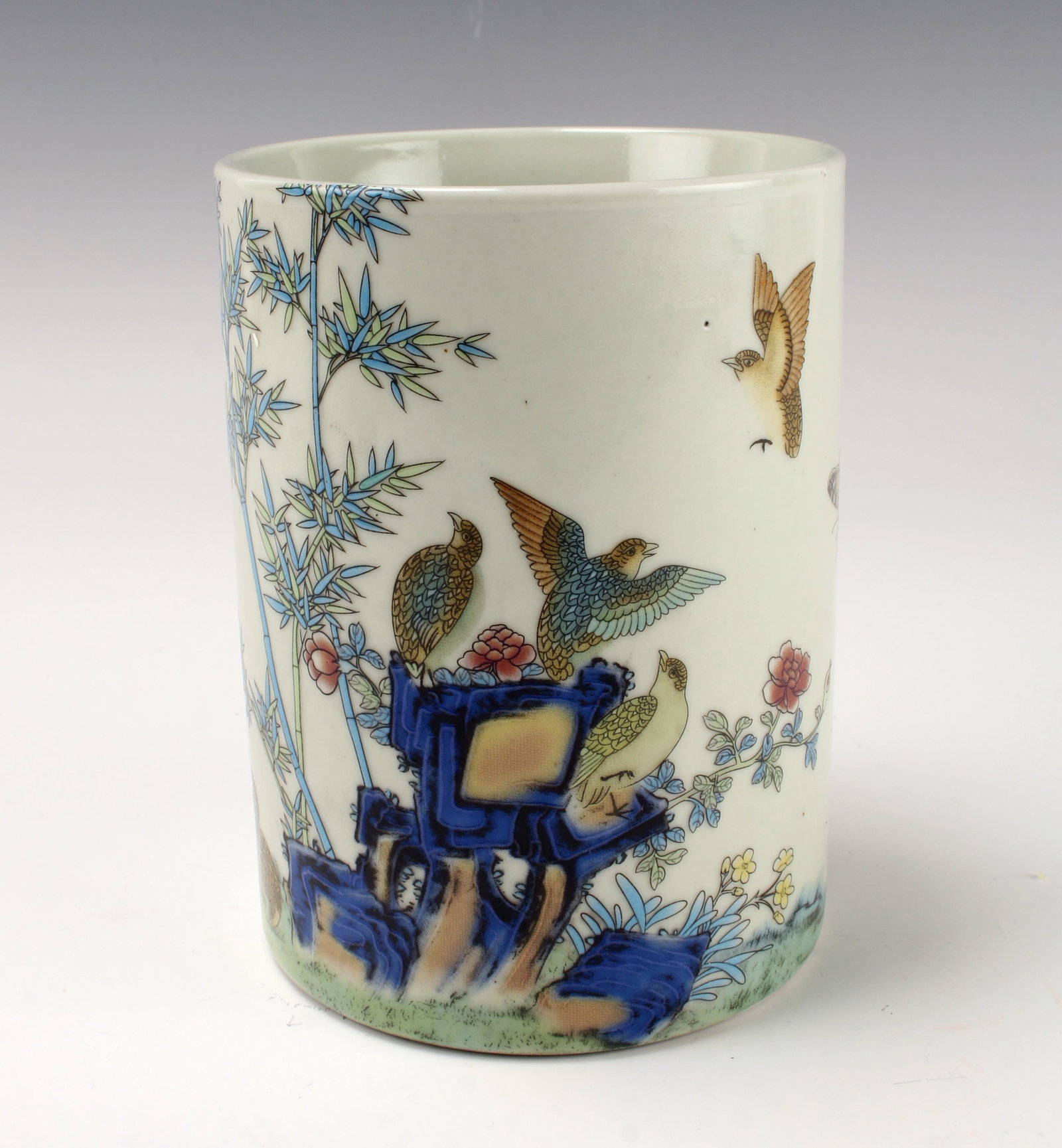 PORCELAIN BIRD BRUSH POT: Garden with birds and butterflies on the body. Calligraphy and artist marks on back of scene. Marked on the bottom. 4" X 5 1/4" $20 - $40 Please contact us for high resolution images