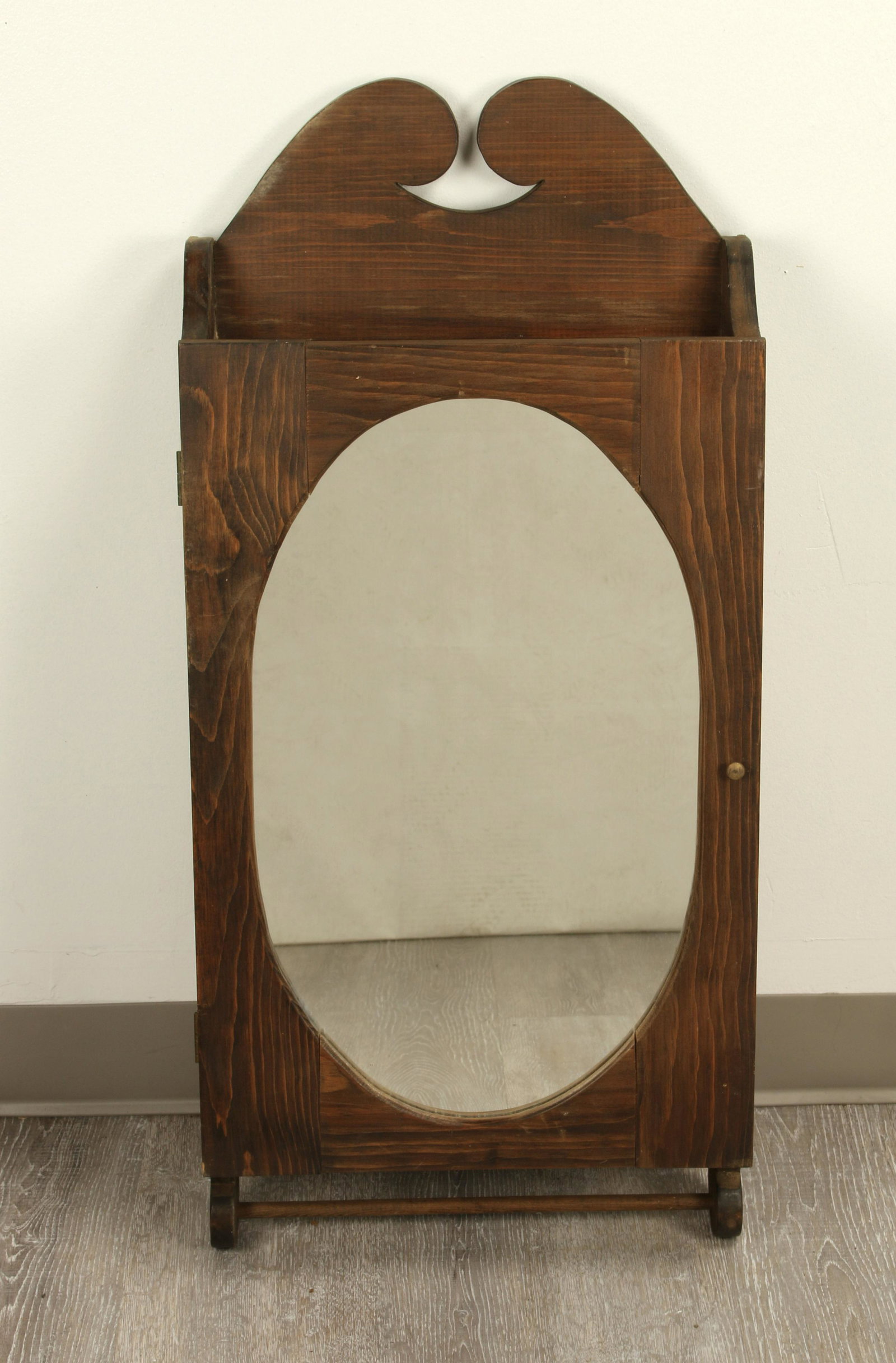 MIRRORED WALL HUNG MEDICINE CABINET: Oval mirror on door, opens to show three shelves. Dowel towel bar on bottom. 35" X 16" X 6" $20 - $40 Please contact us for high resolution images of this lot. Shipping:</