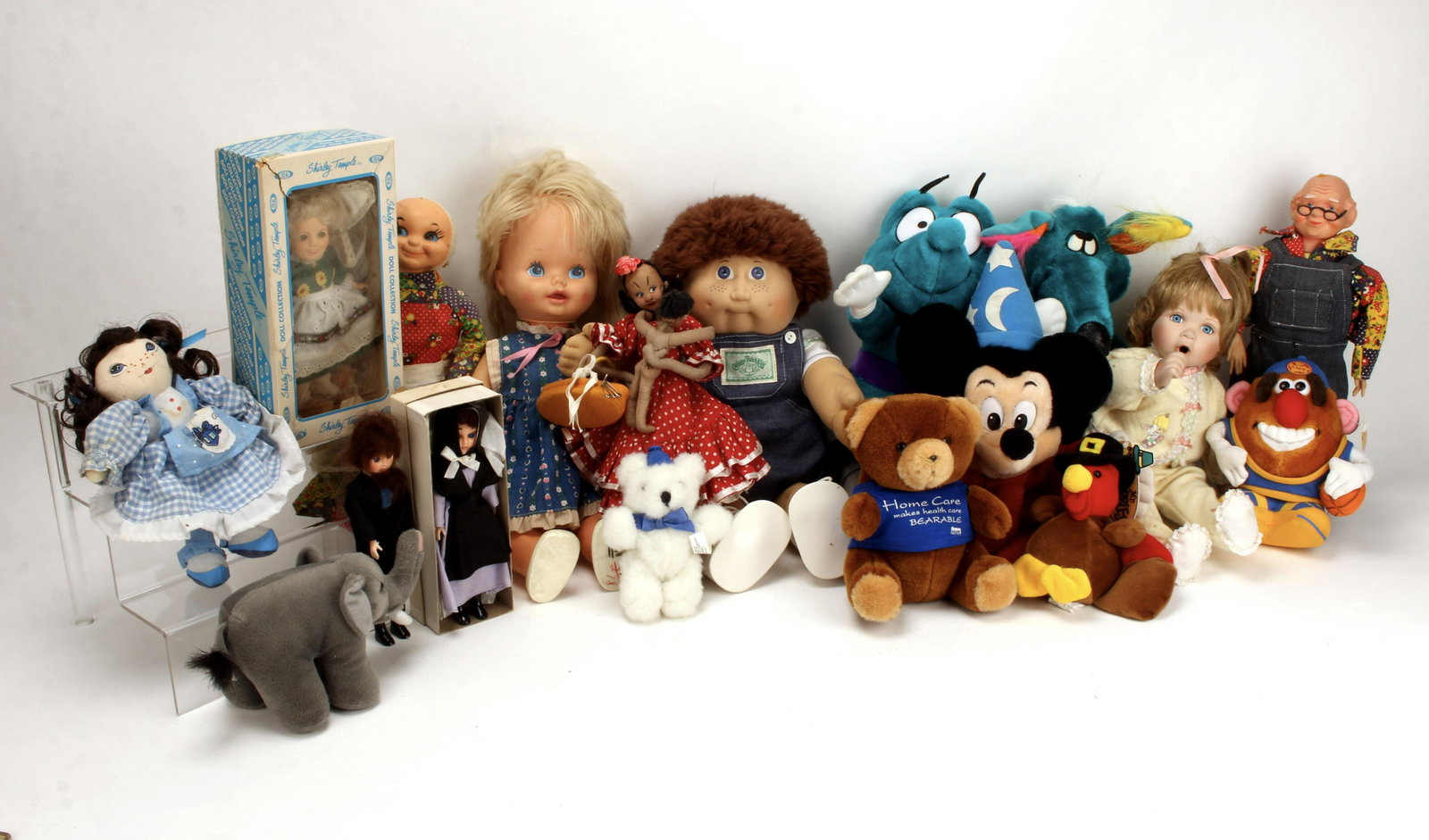 LOT OF STUFFED ANIMALS AND DOLLS: Assortment of dolls. Various dates of manufacture. Includes a Cabbage Patch Kid without it's adoption papers, stuffed Mickey Mouse from Fantasia, Shirley Temple doll in box, an Amish Couple, among oth