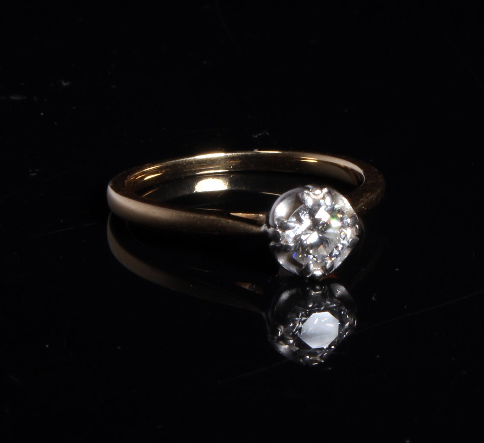 DIAMOND SOLITAIRE ENGAGEMENT RING: Ladies 18K yellow and white gold solitaire diamond engagement ring in a contemporary design set with .30 CT round brilliant cut diamond. Appraisal lists as Clarity VSI, Color G. Includes appraisal.