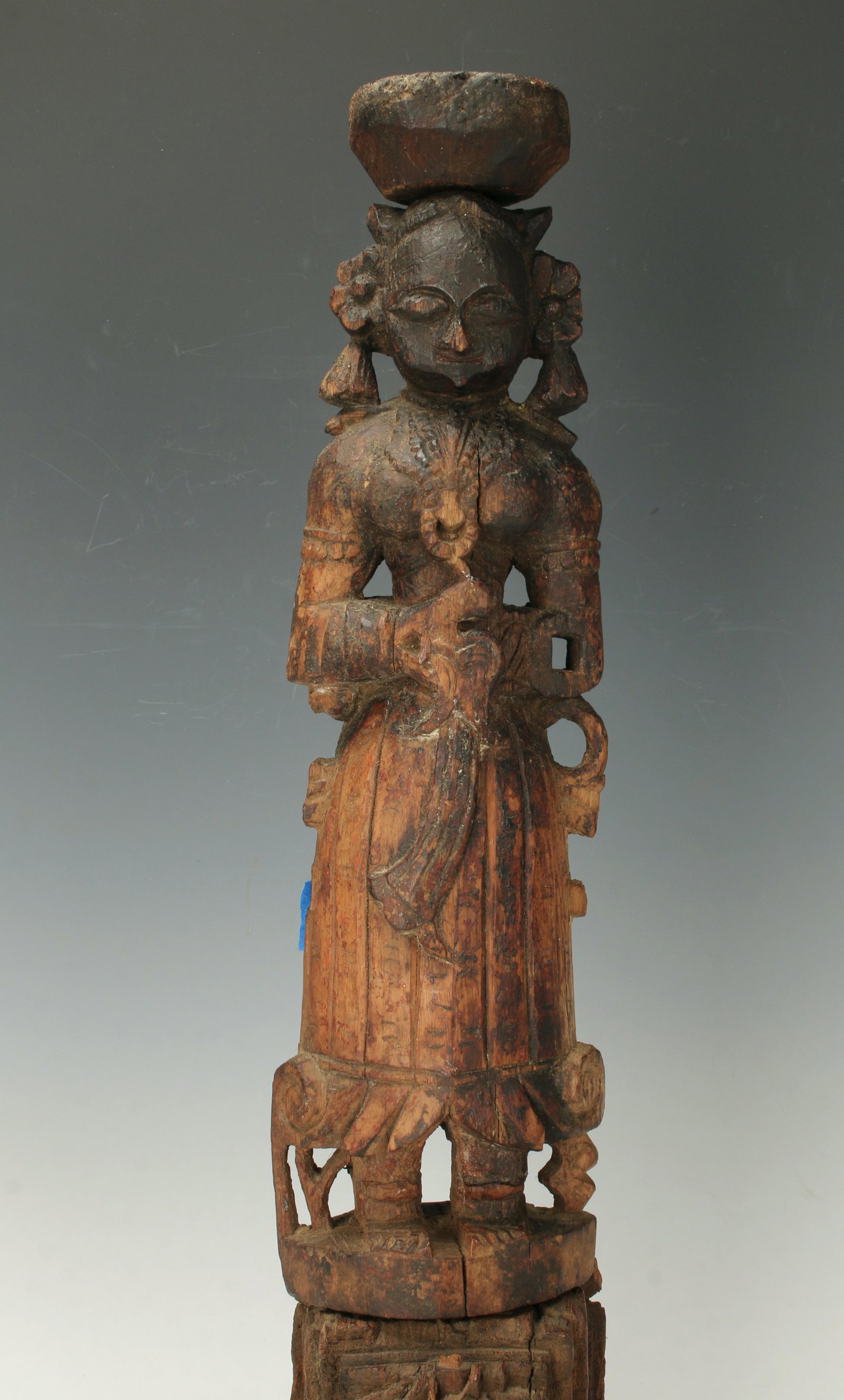 INDIAN CARVED WOODEN 3 PART STATUE OF WOMAN: The figure fits in to slot on base. Carved breast plate and jewelry. Cup form at top of head is removable. 4" X 20" $40 - $80 Please contact us for high resolution images of this lot.