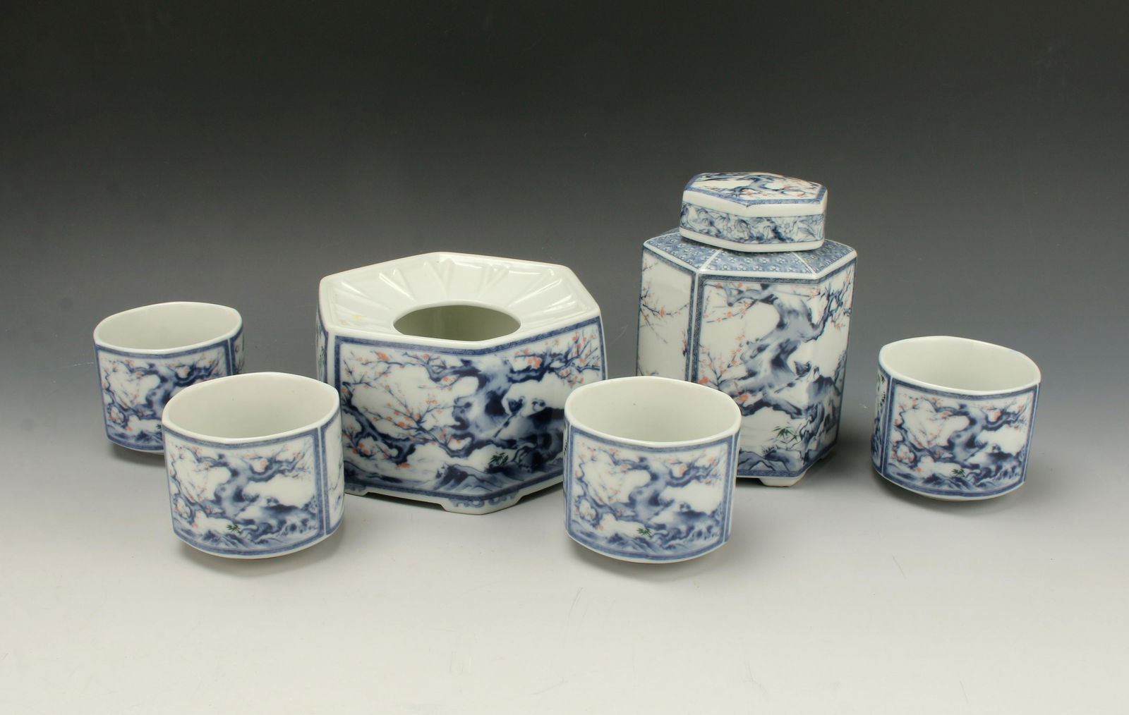ASIAN PORCELAIN TEA CADDY SET WITH PLANTER: Tea caddy with four cups and a planter. Blue and white with pink flowers. 5 1/2" X 3 1/2" $40 - $80 Please contact us for high resolution images of this lot. Shipping: <