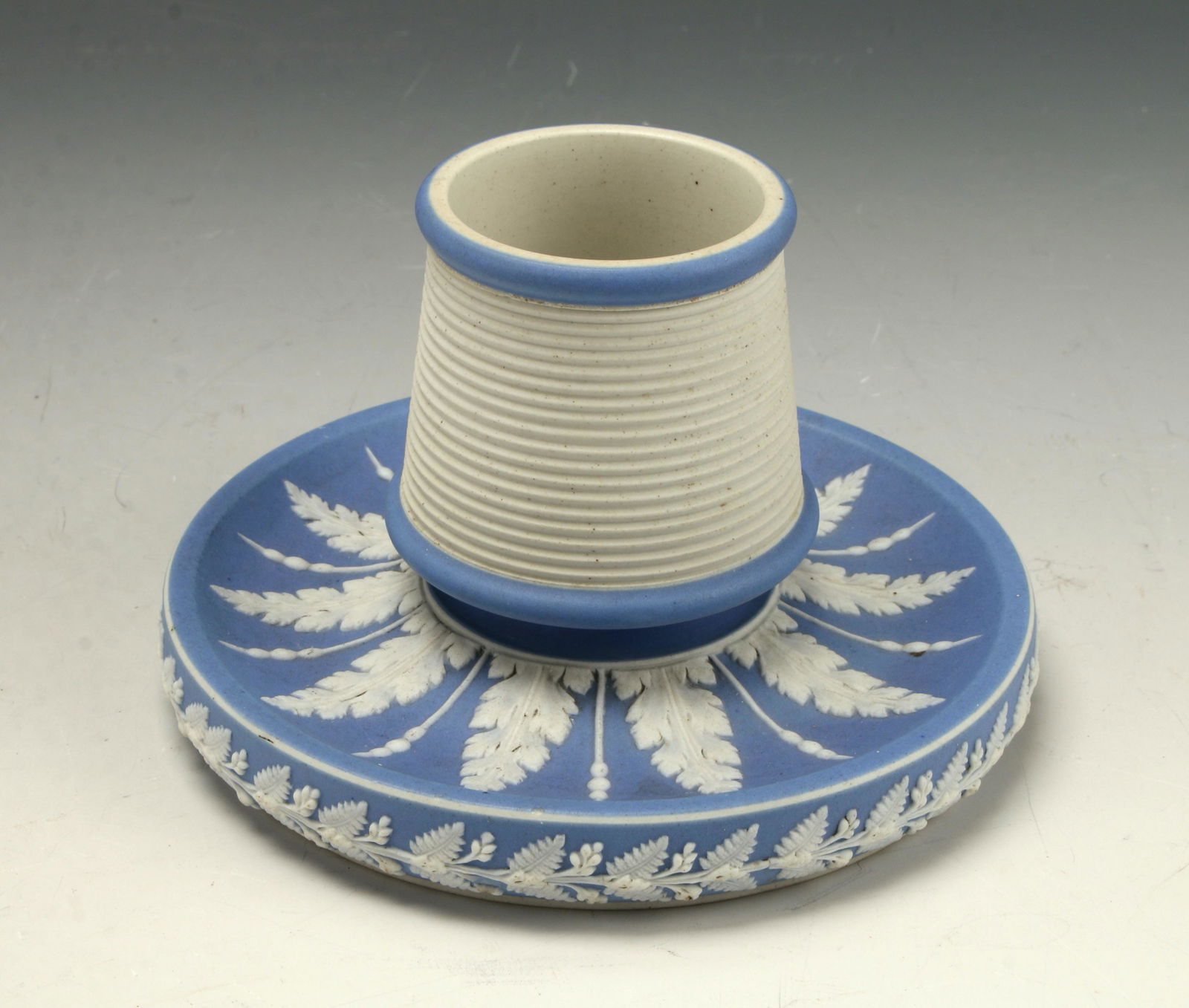 BLUE JASPERWARE TOOTHPICK HOLDER CANDLESTICK: Blue & white ridged body on a base of leafy foliage. For toothpicks, candles, or as a low vase. Unmarked. 5" x 3" $40 - $80 Please contact us for high resolution images of this lo